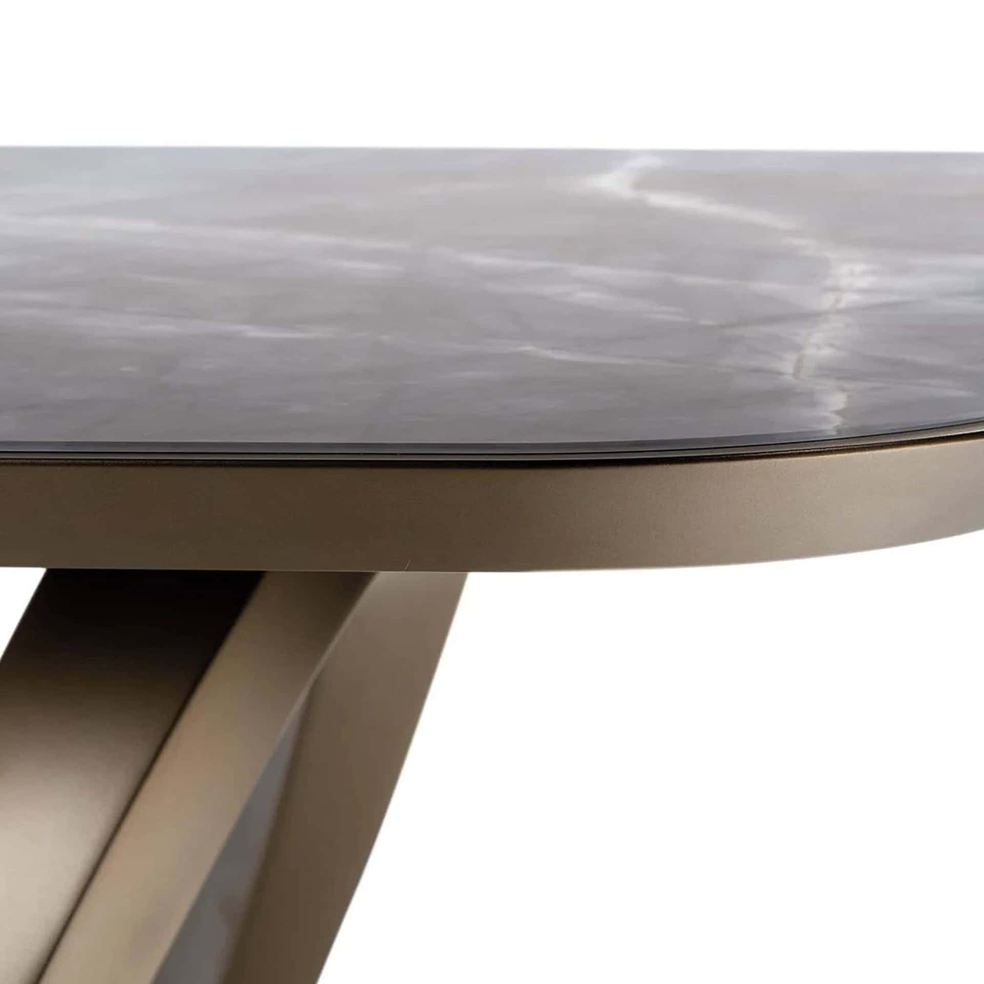 Close-up of Segno 72 Dining Table’s bronze finished base with curved details