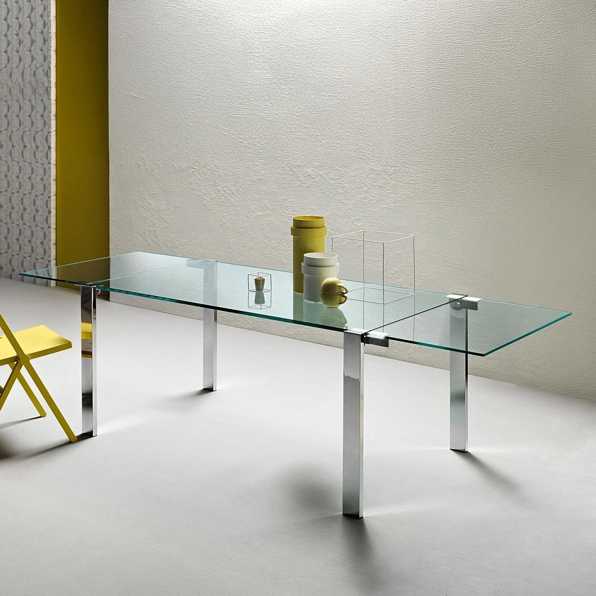 Livingstone Extendable Dining Table with glass top and chrome legs in a bright modern dining space