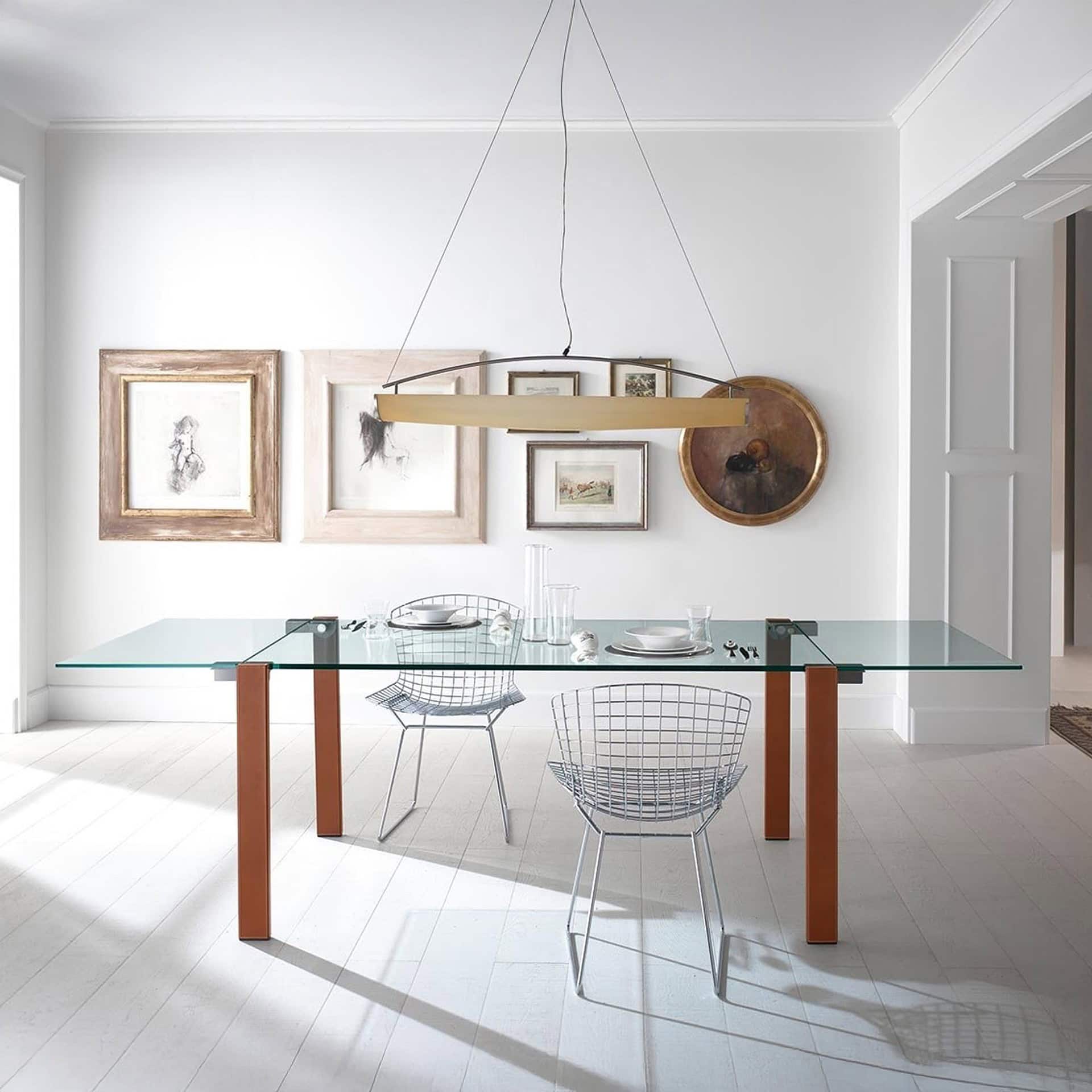 Livingstone Dining Table with wood legs shown extended in a light-filled interior