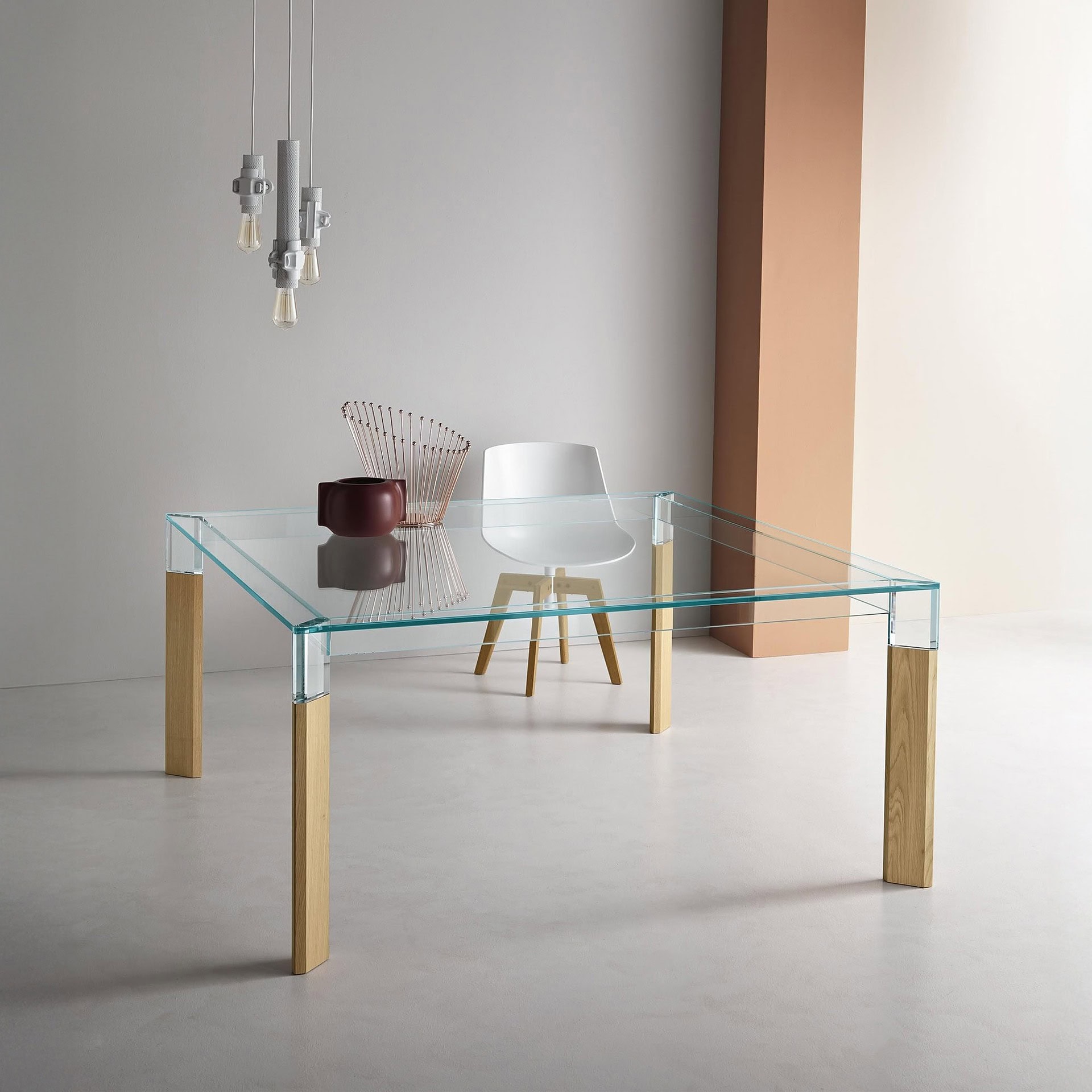 Perseo Extra-Clear Glass Dining Table styled in a modern room with glass top and wood legs paired with contemporary chairs