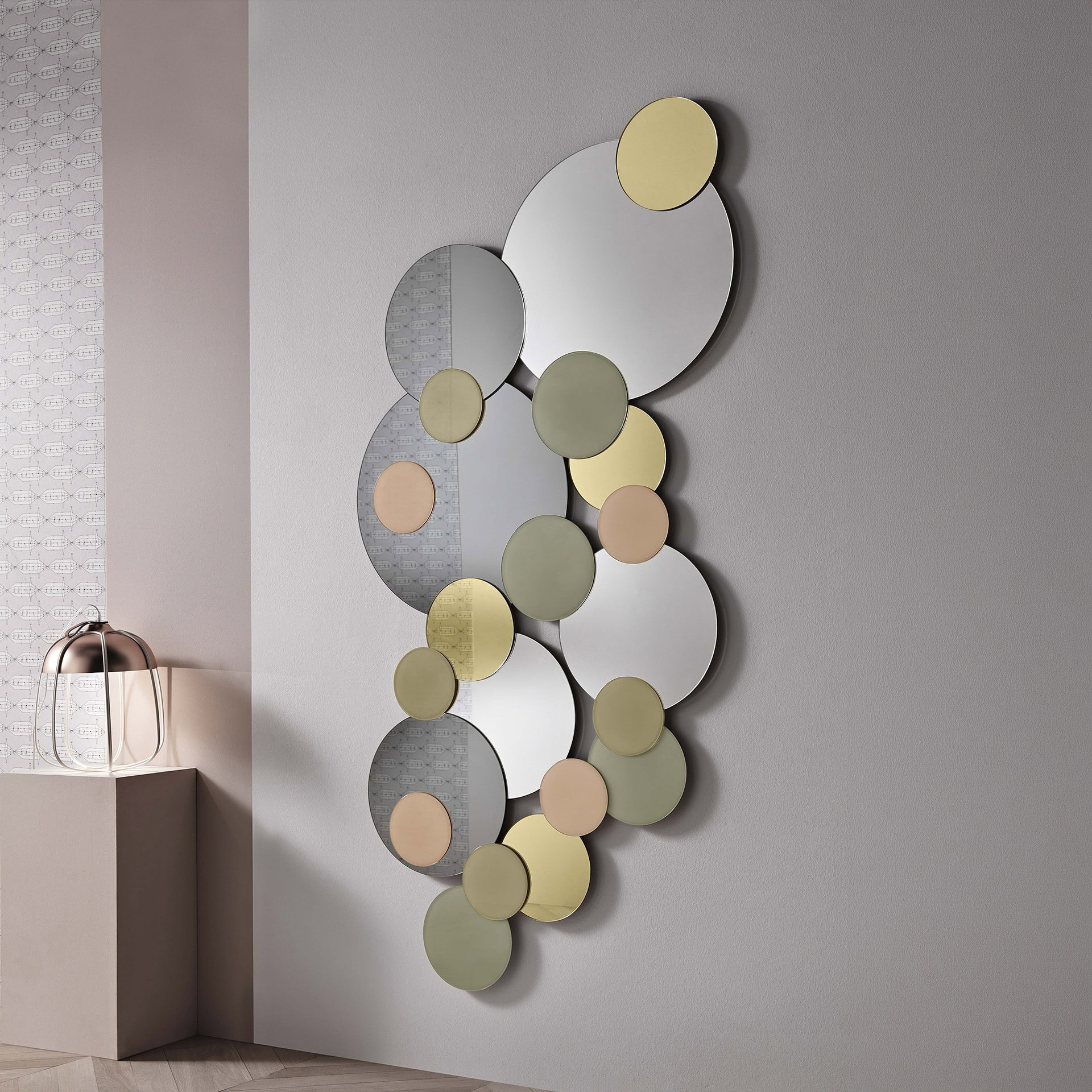 Modern sculptural wall mirror with circular elements in neutral tones.