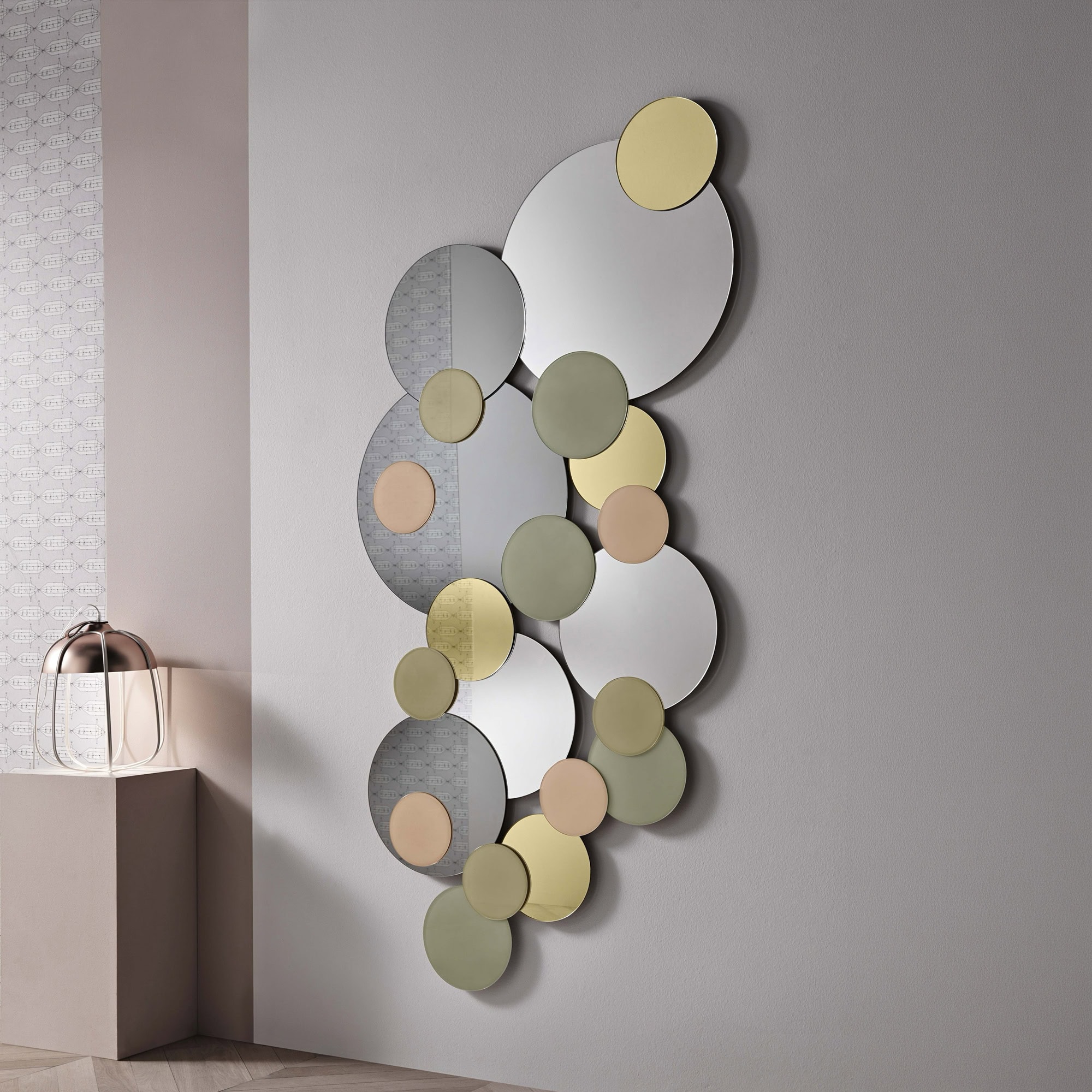 Modern sculptural wall mirror with circular elements in neutral tones.