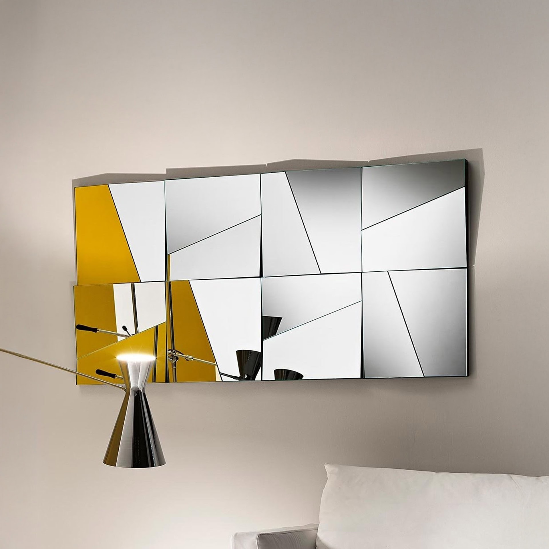Stati d’Animo modular wall mirror with concave and convex panels arranged in a clean geometric composition above a modern sofa.