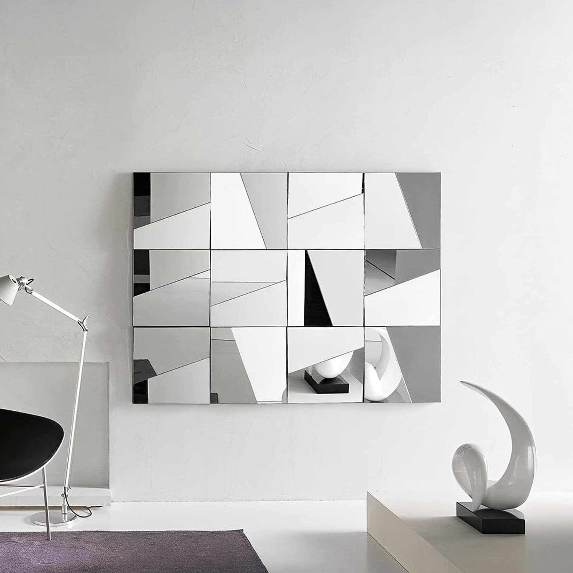 Stati d’Animo mirror composition styled in a bright modern living room above a lamp and console table.