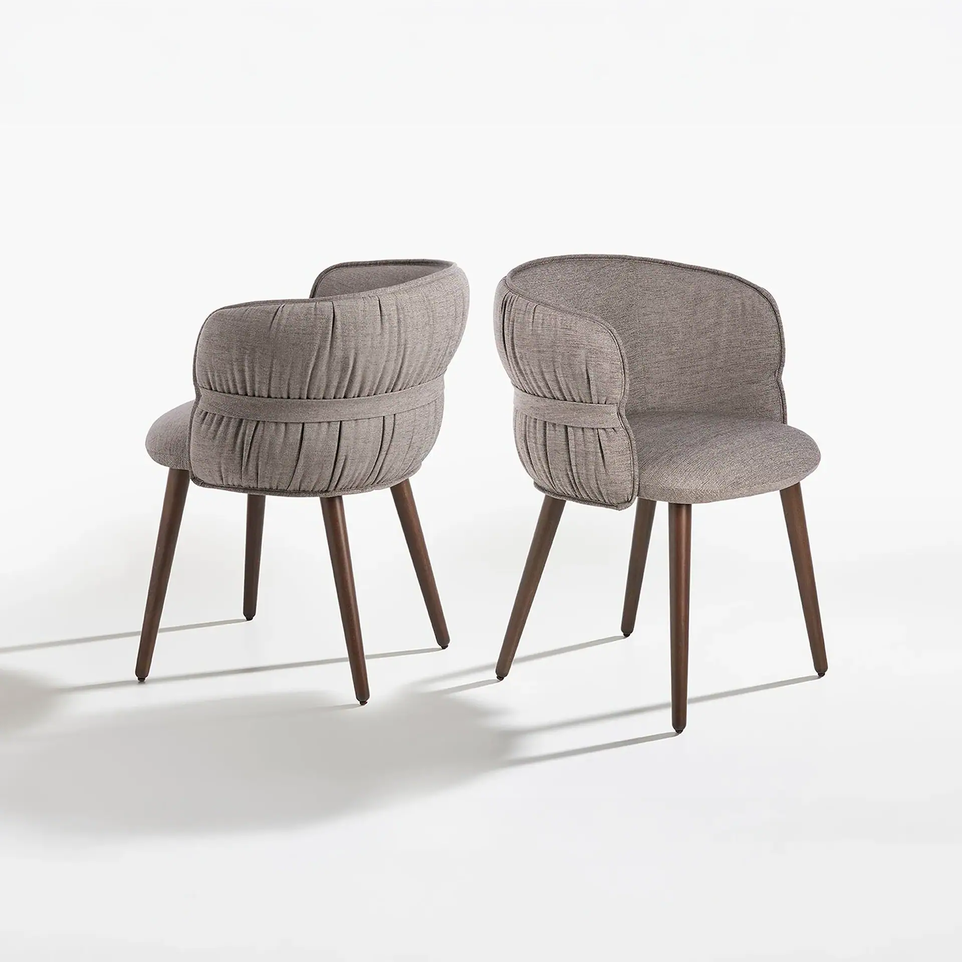 Modern grey armchairs with wooden legs from Sklar Furnishings.