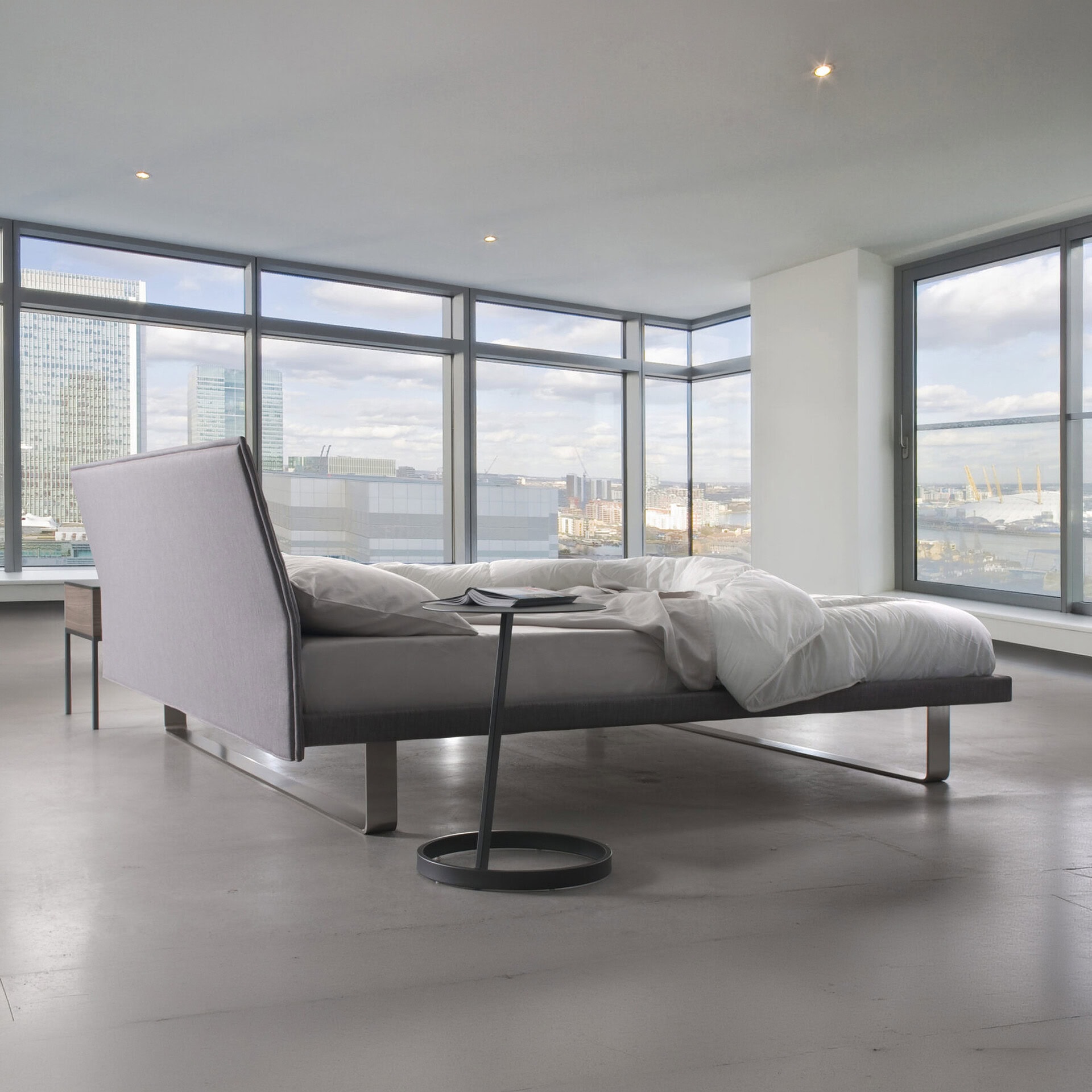Envy upholstered platform bed with modern design in a bright city apartment.