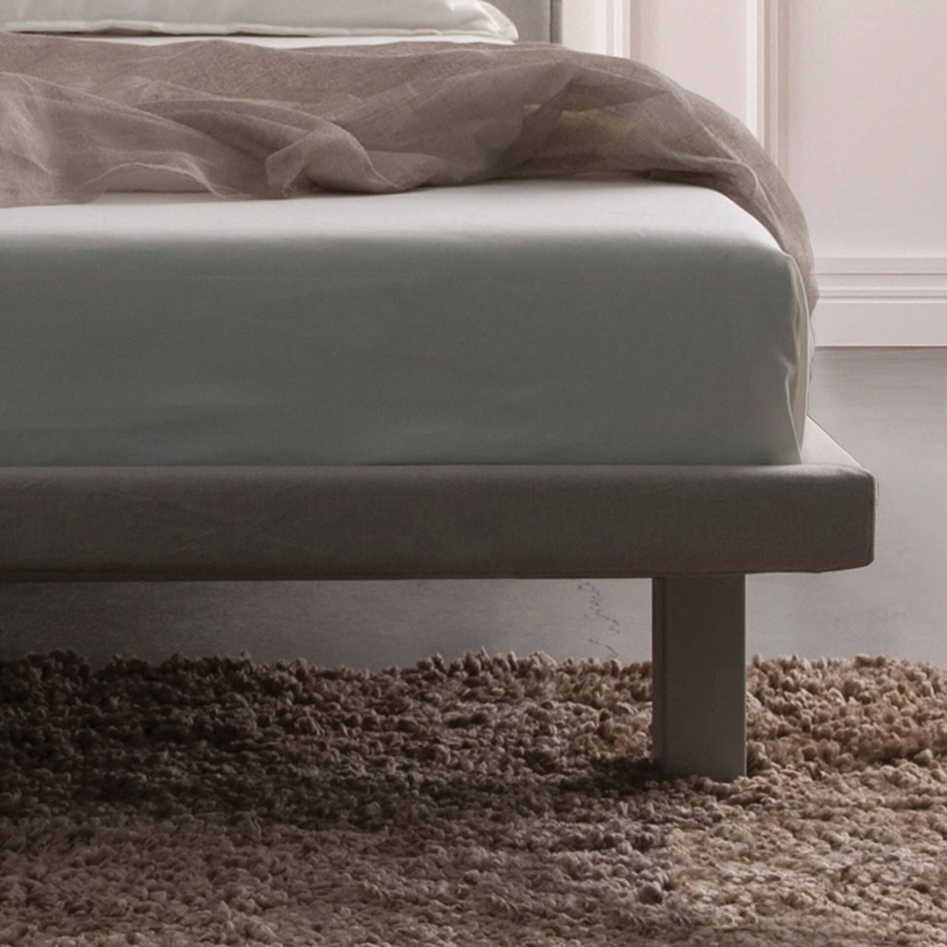 Envy upholstered platform bed with sleek design and neutral tones. Perfect for modern bedrooms and s.