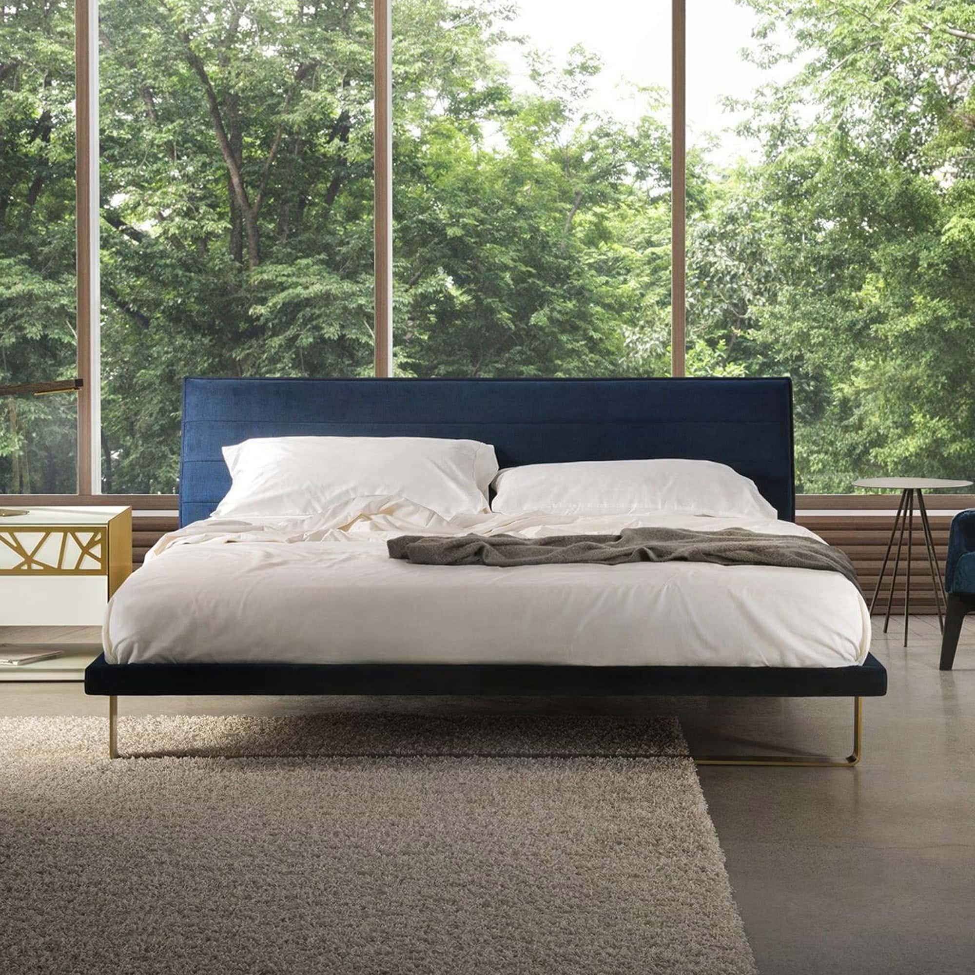 Elegant blue upholstered platform bed with a modern design. Perfect for contemporary bedrooms, offer.