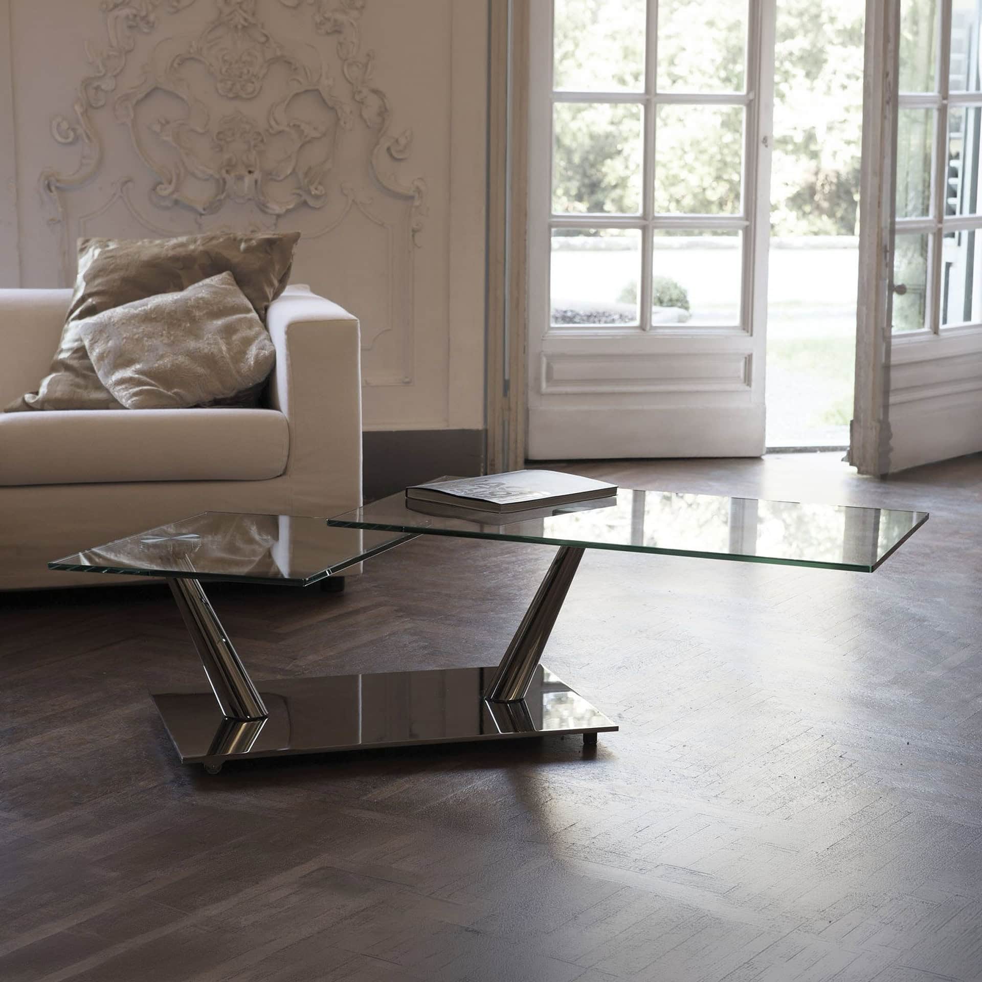 Elegant Aqui Motion Cocktail Table with glass top and contemporary metal base.