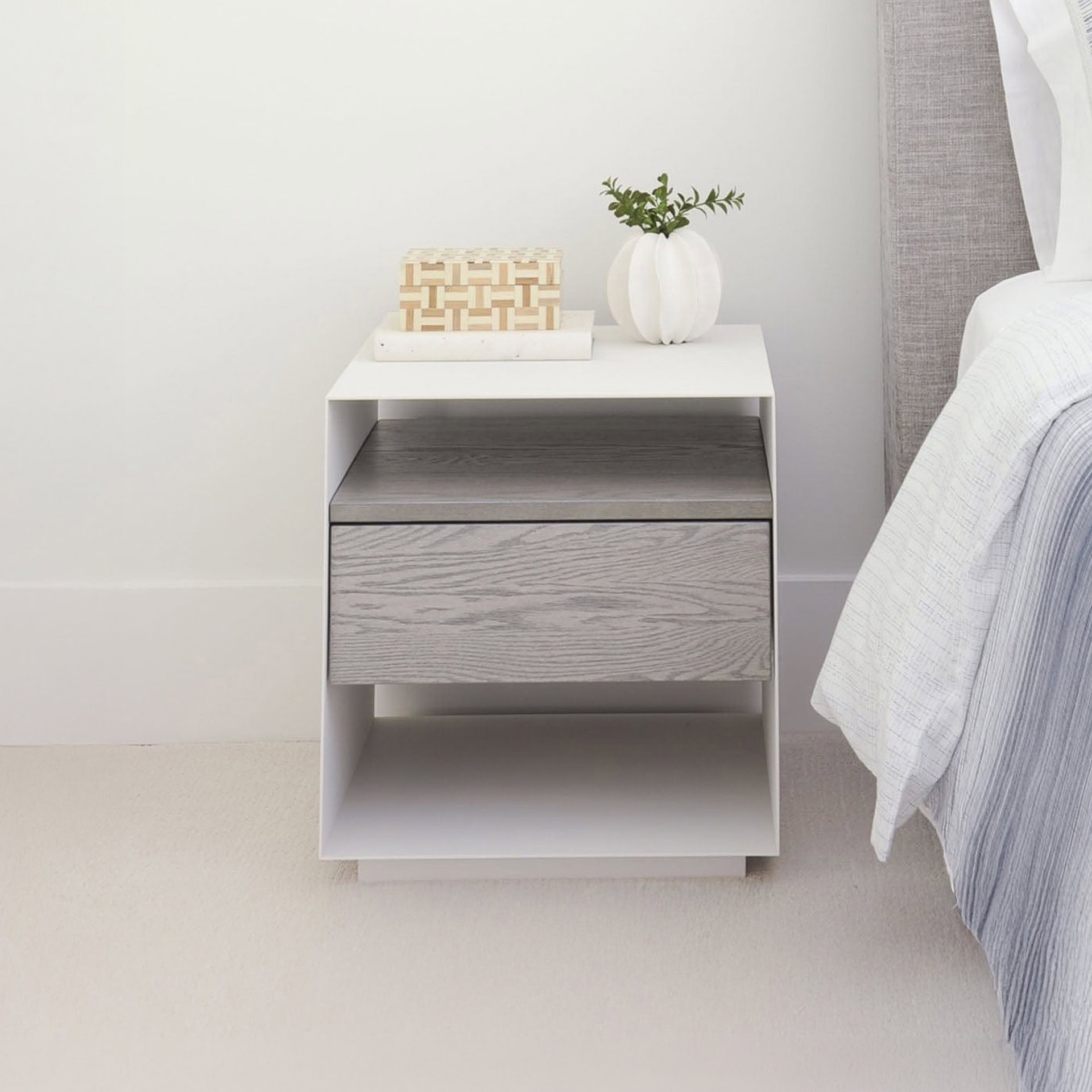 Contemporary bedroom nightstand with drawer and open shelf, neutral gray finish.