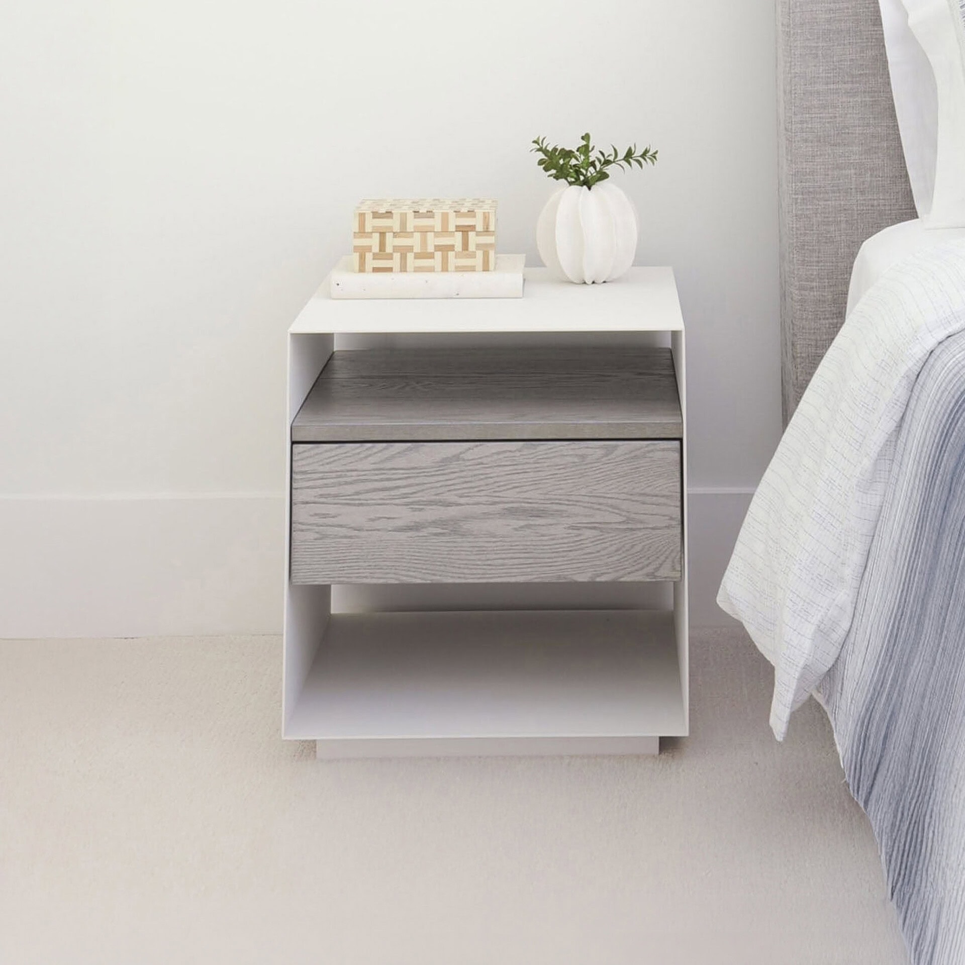 Contemporary bedroom nightstand with drawer and open shelf, neutral gray finish.