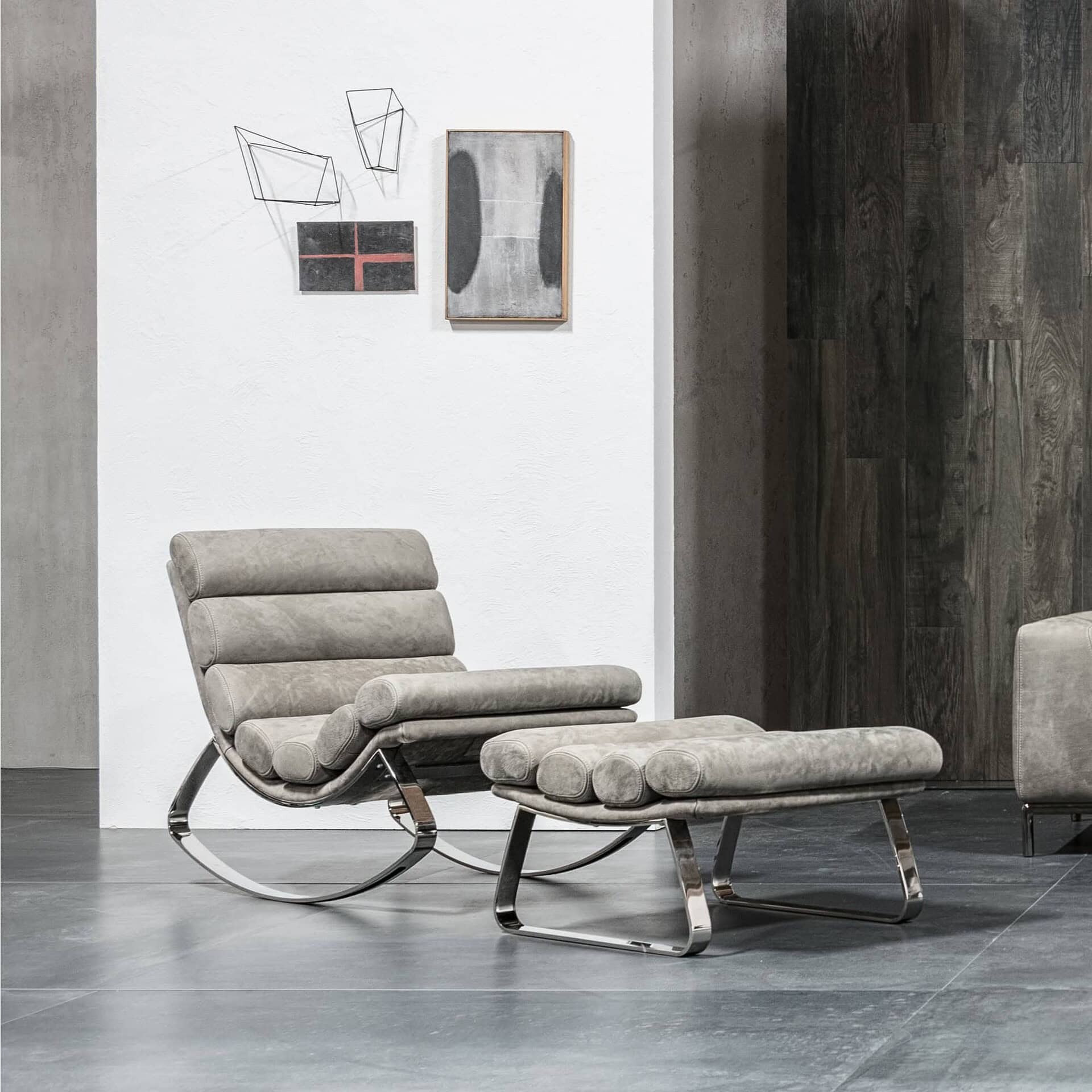 Monet Rocking Chair and ottoman in taupe leather with chrome base, styled in modern interior setting.