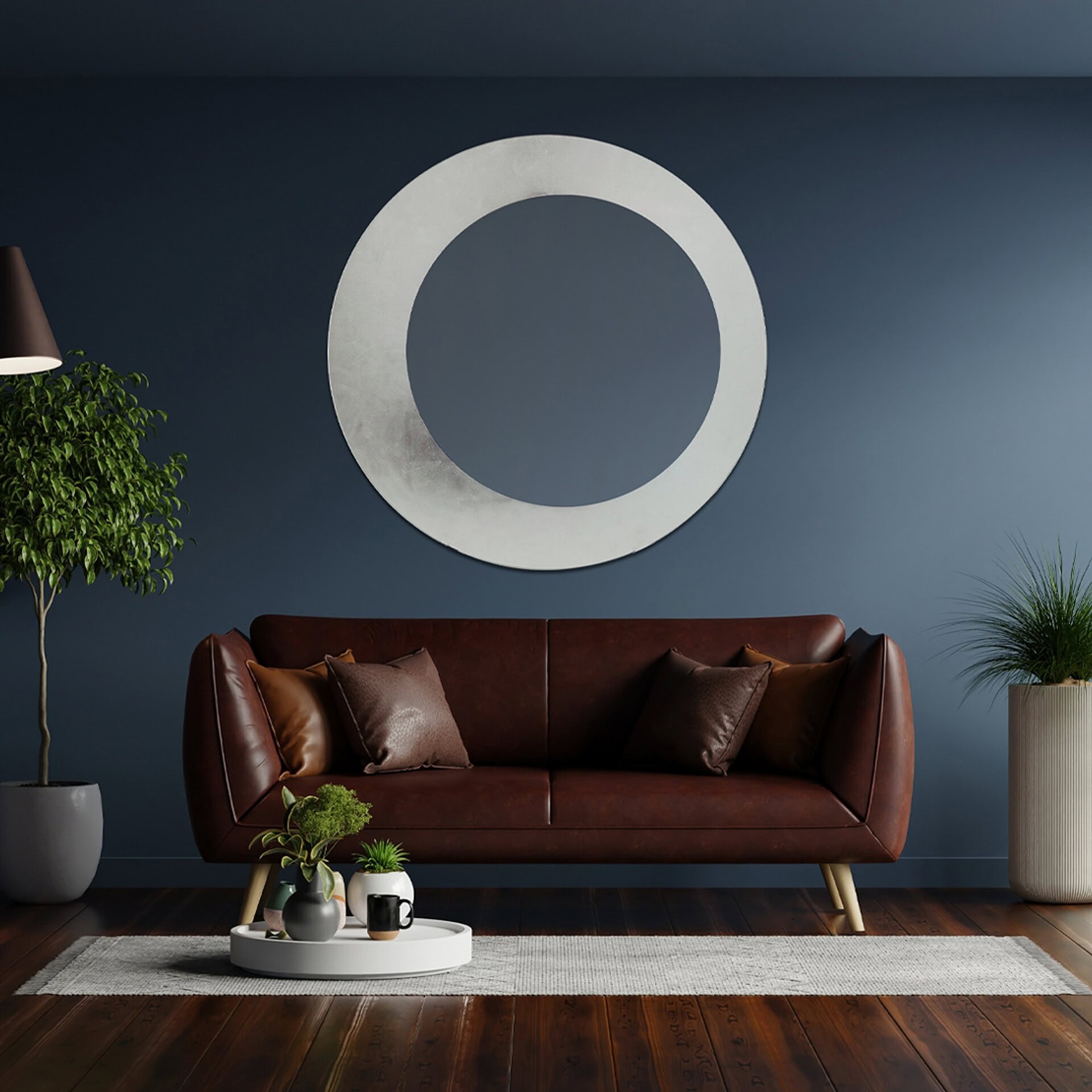 Olio Mirror with frosted glass frame styled above a modern sofa in a dark blue living room.