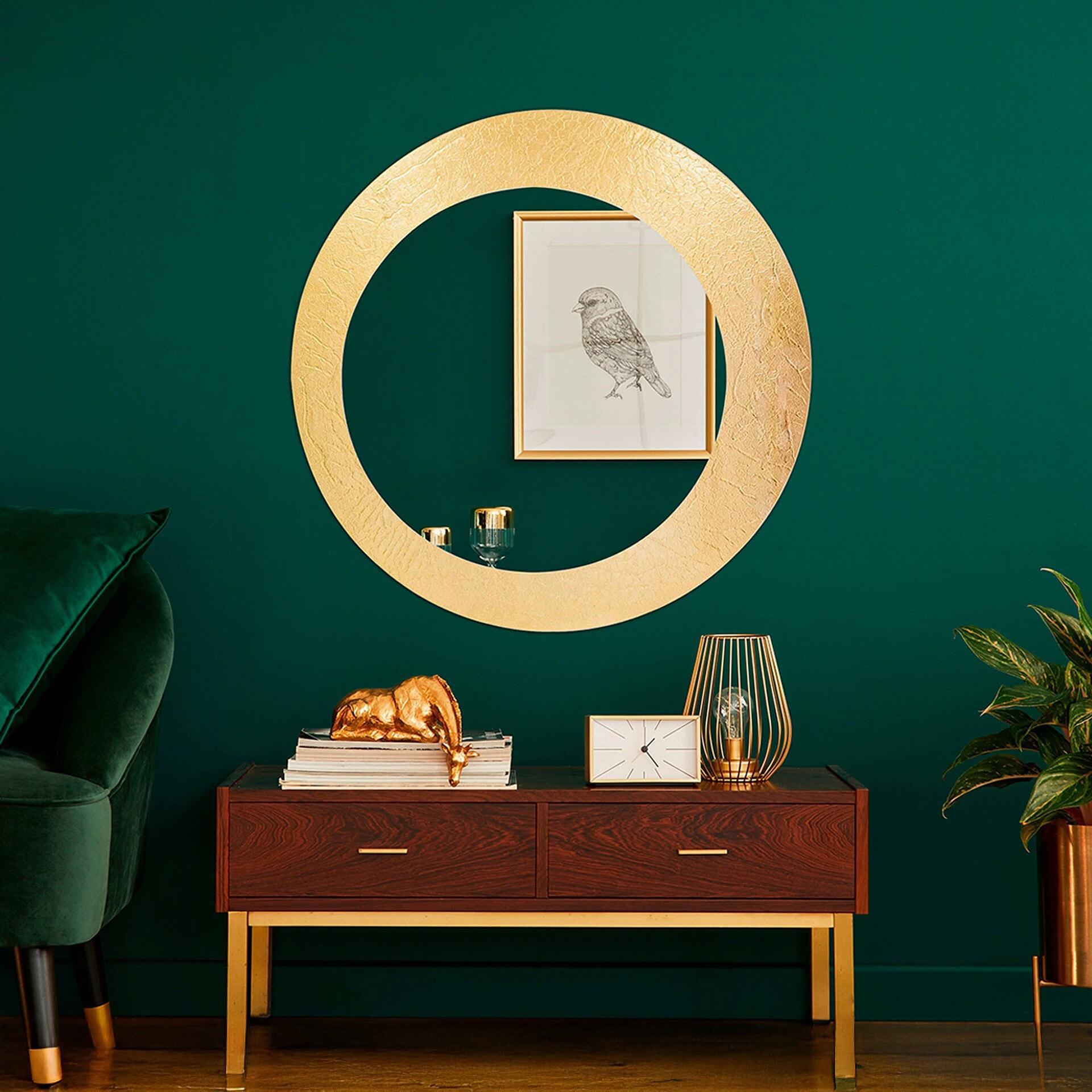 Olio Mirror with golden glass frame styled above a console in a green-walled interior.