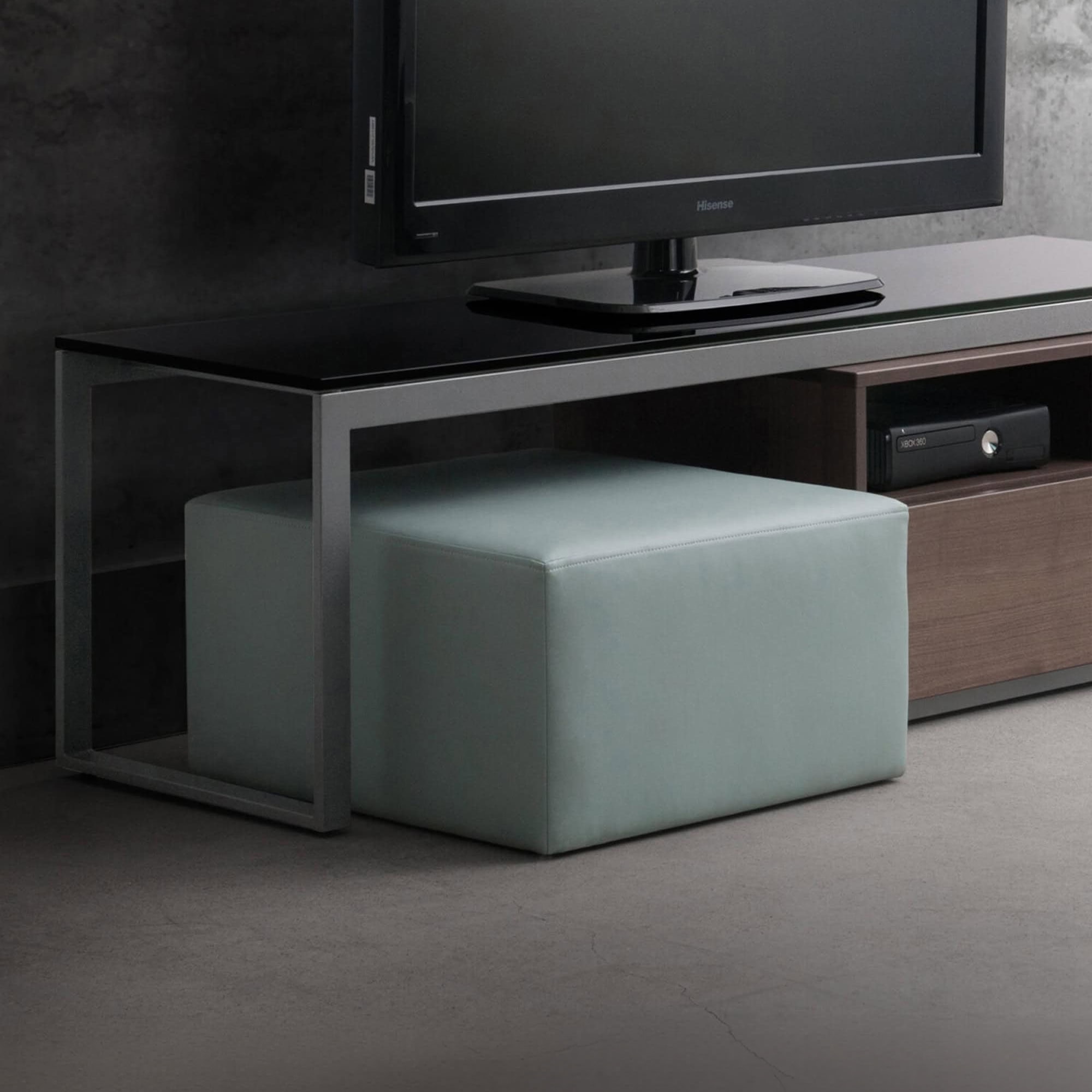 Contemporary upholstered ottoman in a sleek living room setting, perfect for extra seating or footre.