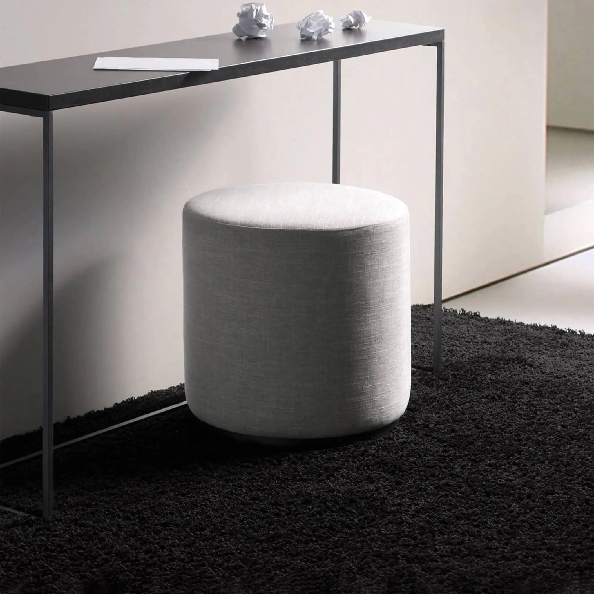 Modern Marshmallow Ottoman in neutral fabric with black metal table.