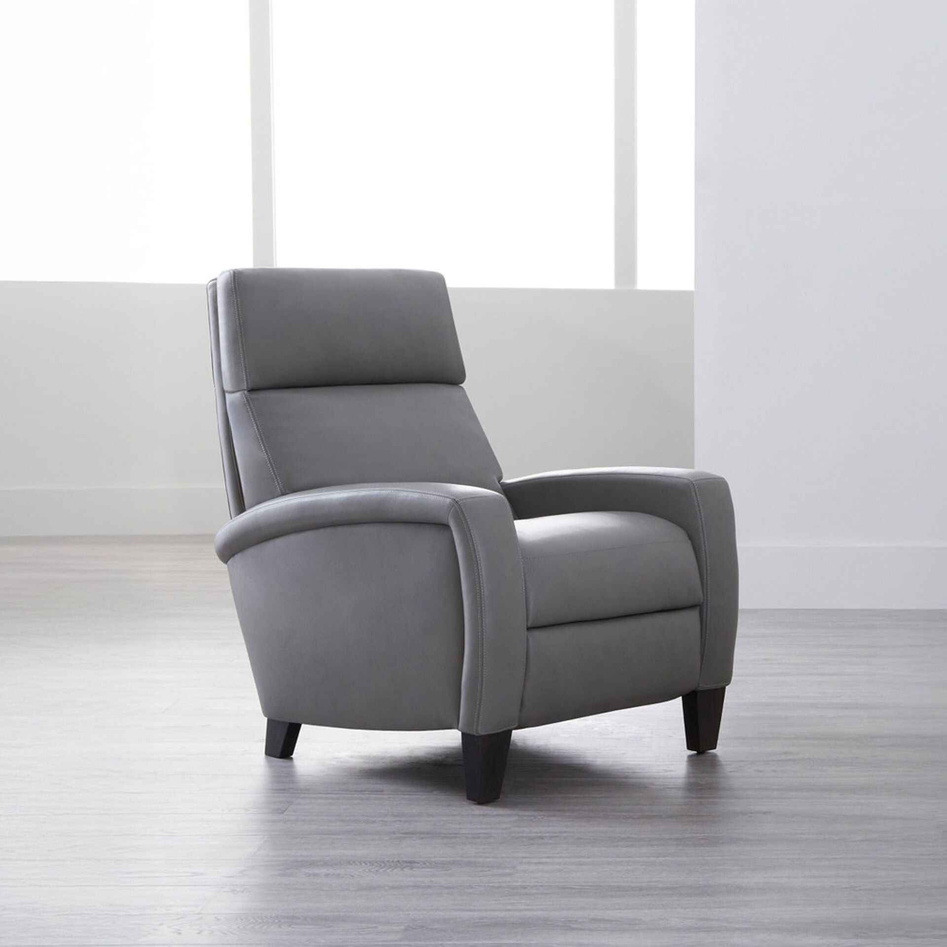 Dexter Comfort Recliner in a neutral gray fabric, angled view.
