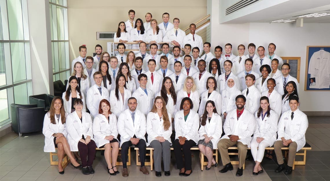 Diverse group of medical professionals in white lab coats at Sklar Furnishings.