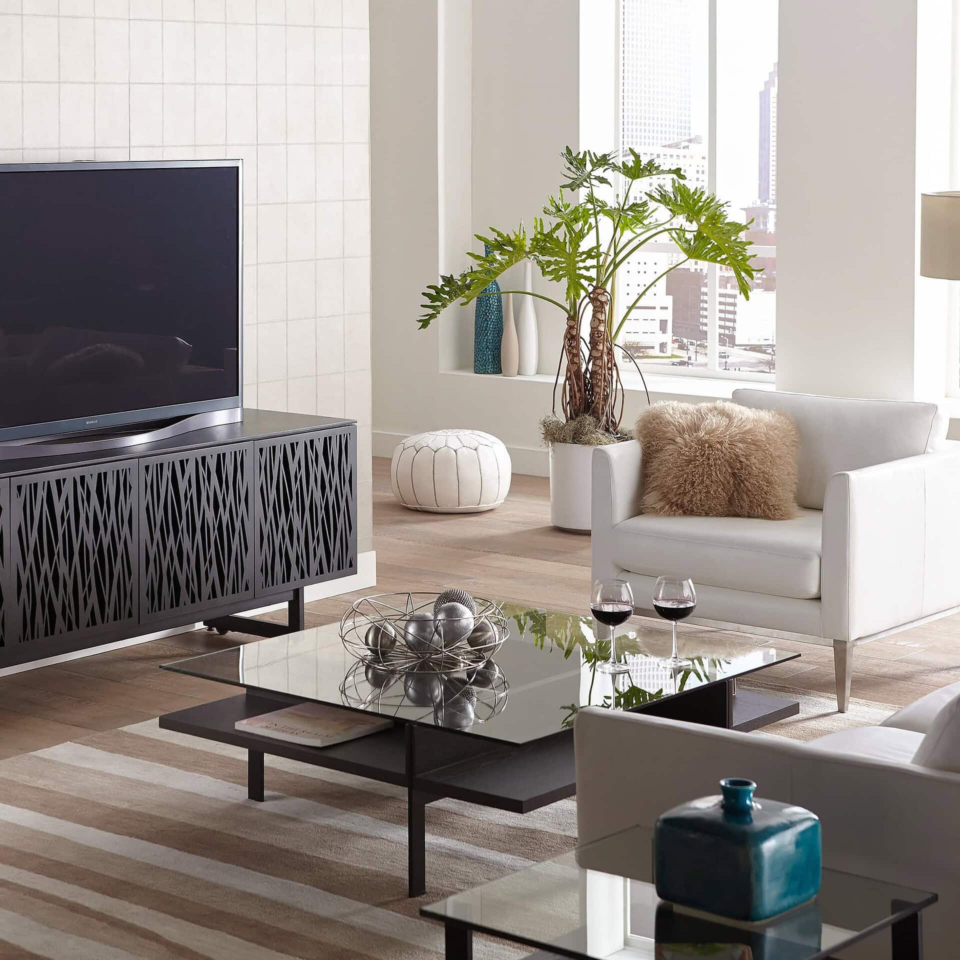 Contemporary living room with modern furniture, large window, and decorative accents for stylish comfort.