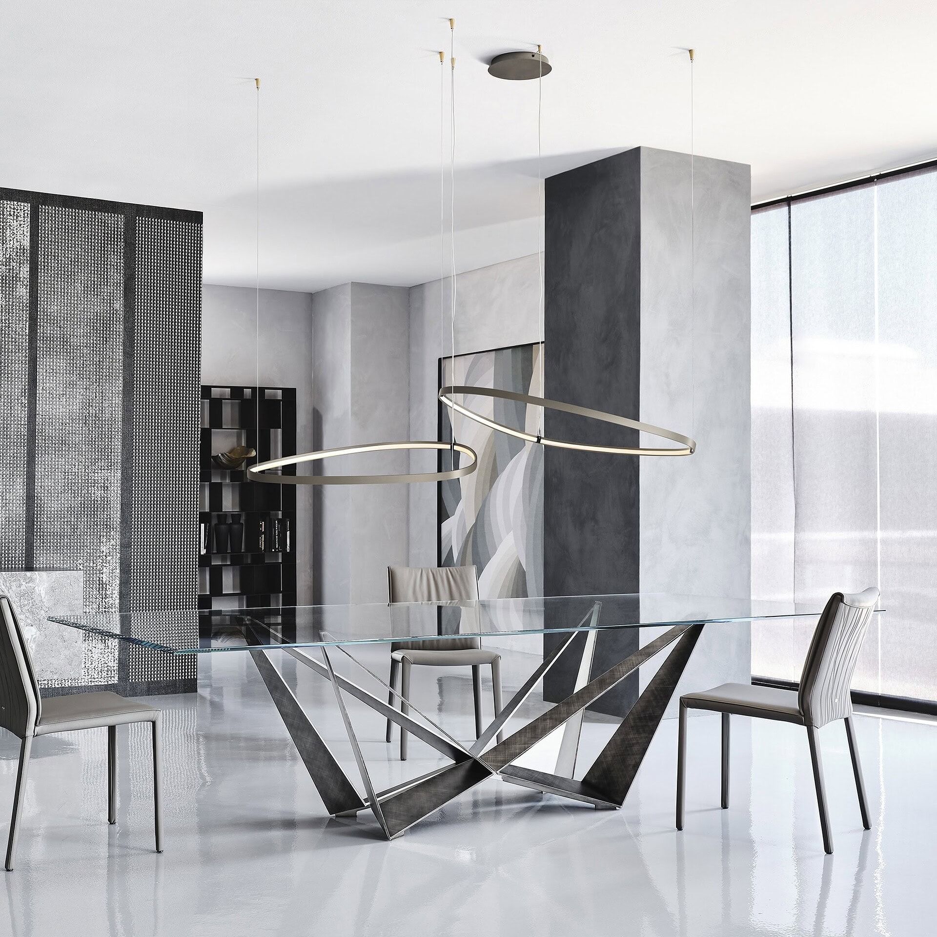 Skorpio dining table with clear glass top and graphite steel base in a modern dining room.