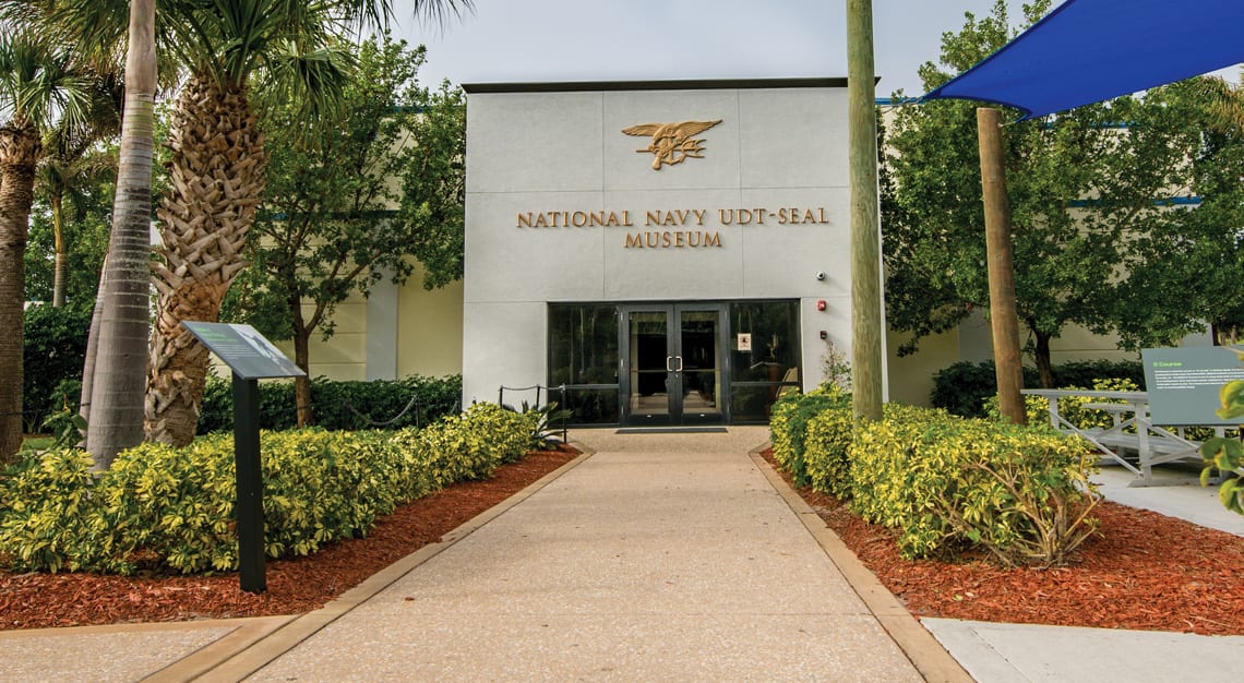 1. Navy UDT-SEAL Museum entrance with lush landscaping and clear signage for military history.