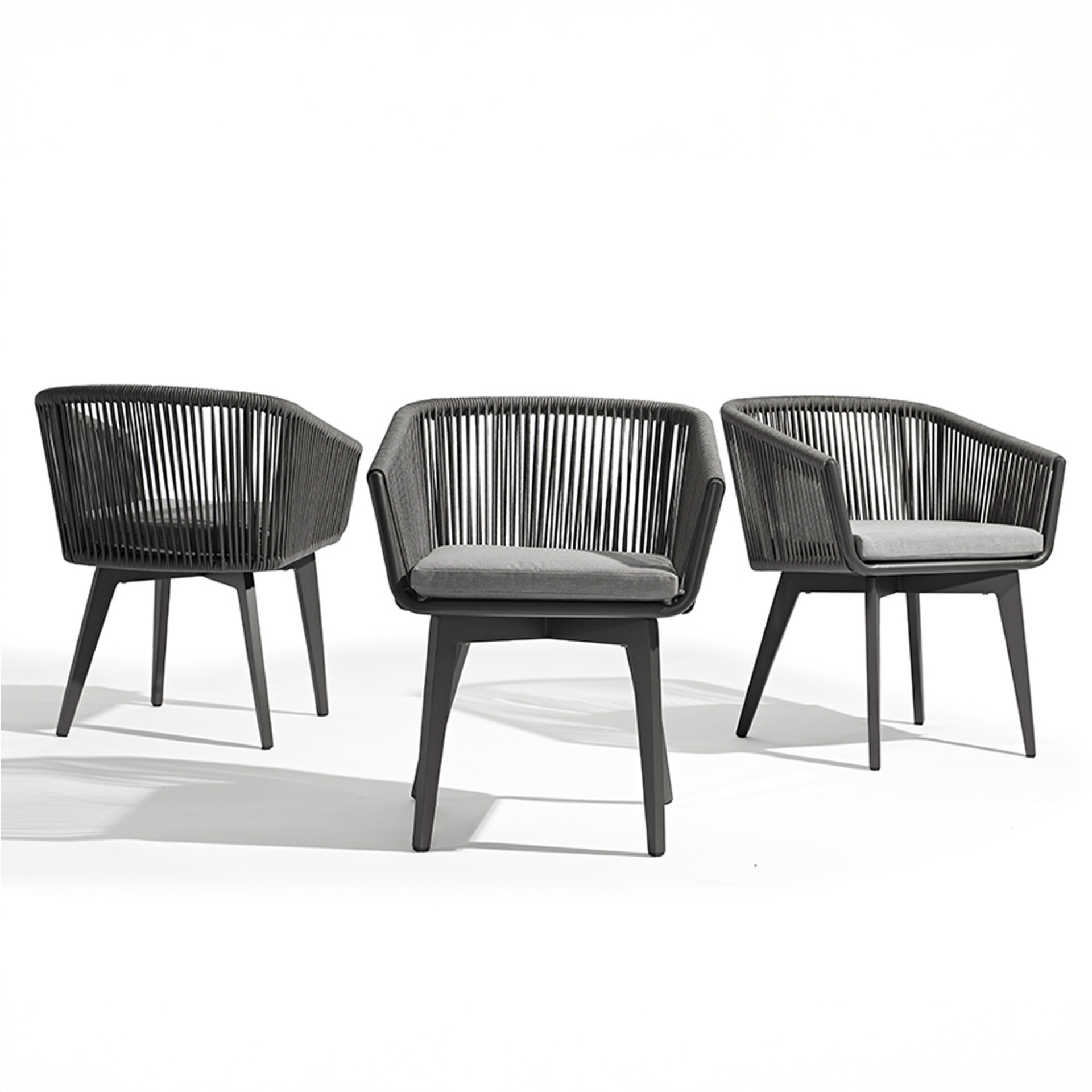 Three modern dark gray armchairs with woven backs and light gray cushions, arranged on a white background.