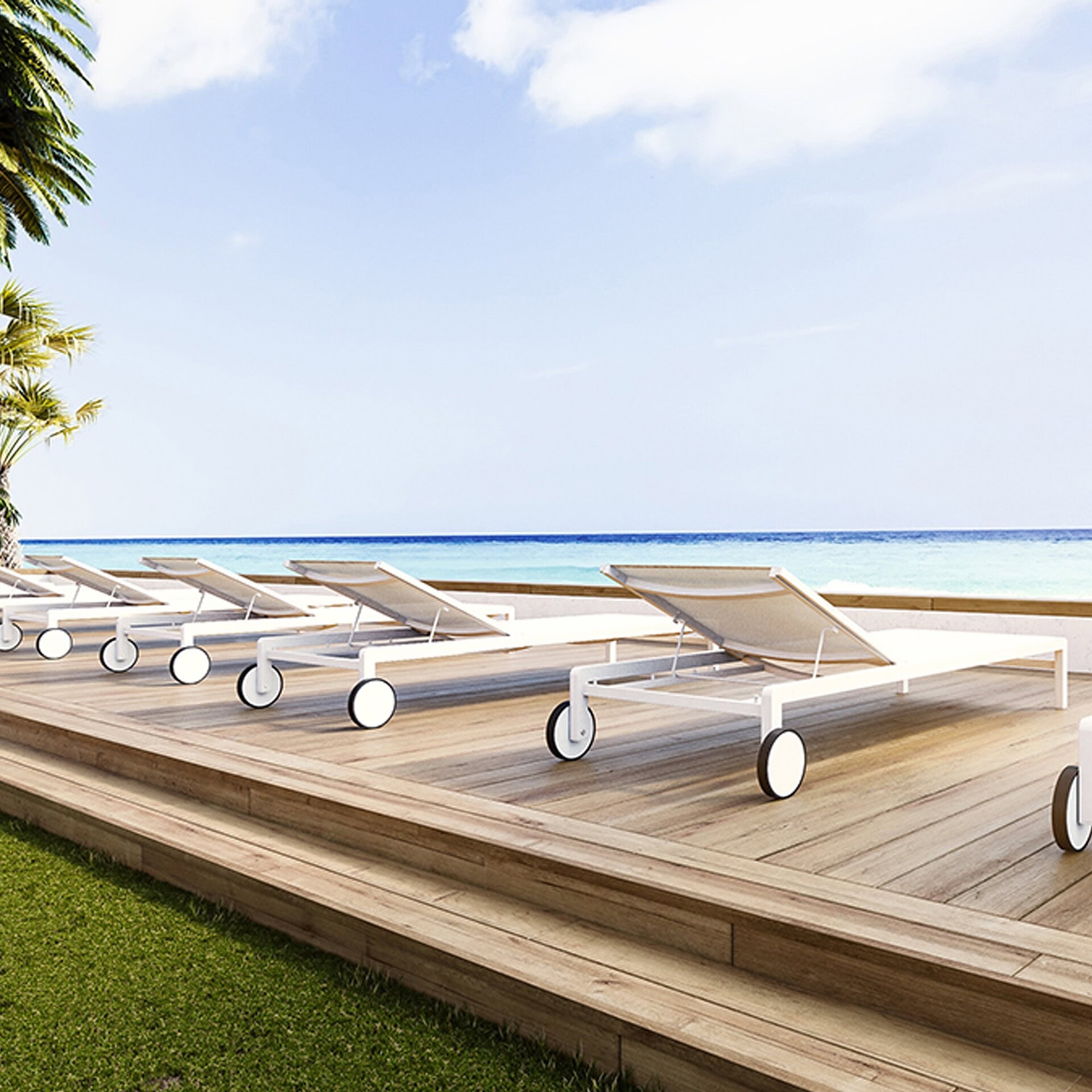 Row of Ella Chaise Lounges with white frames by a modern pool deck overlooking the ocean.