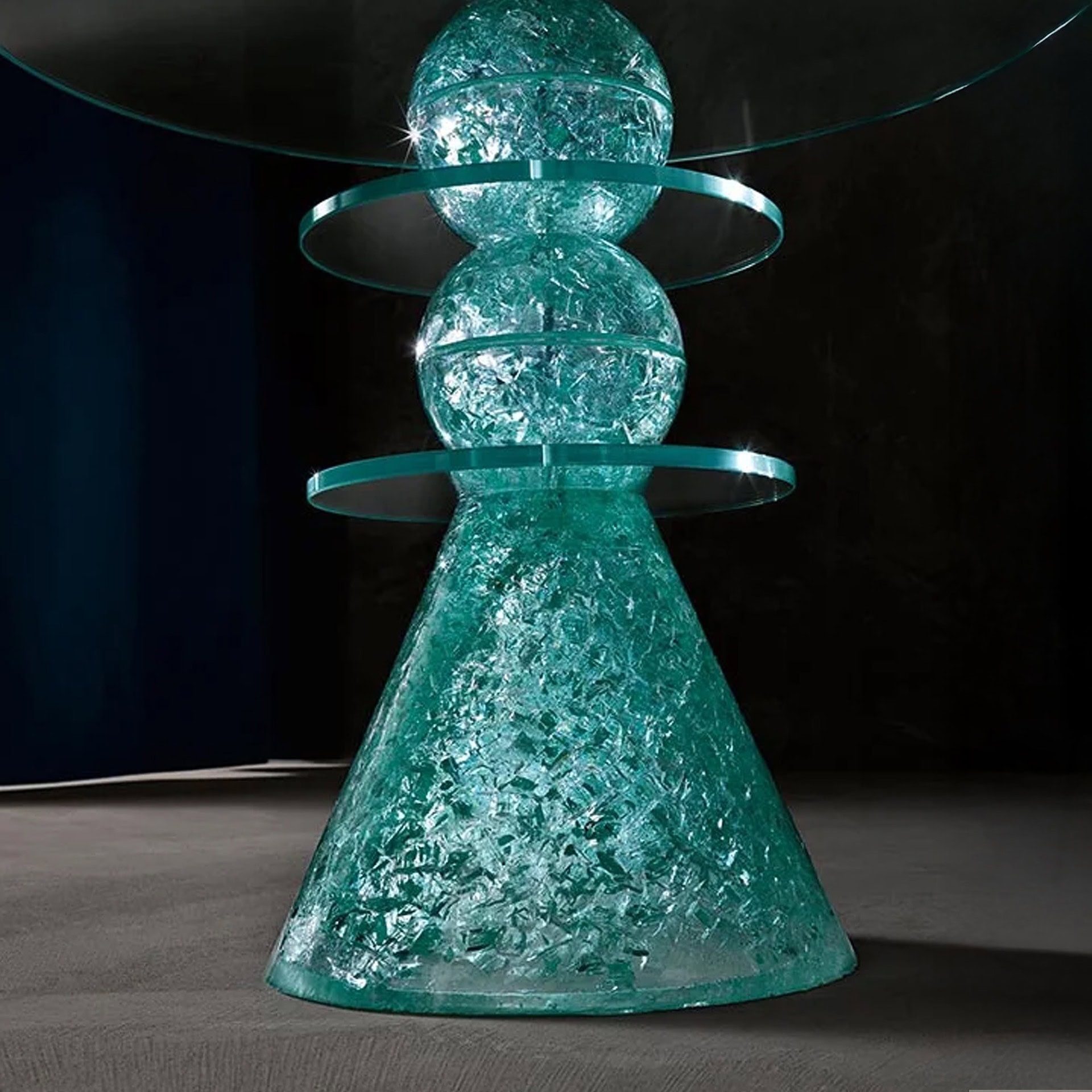 Il Paese delle Meraviglie Side Table with teal glass base and smoked glass top, displayed in a modern living room