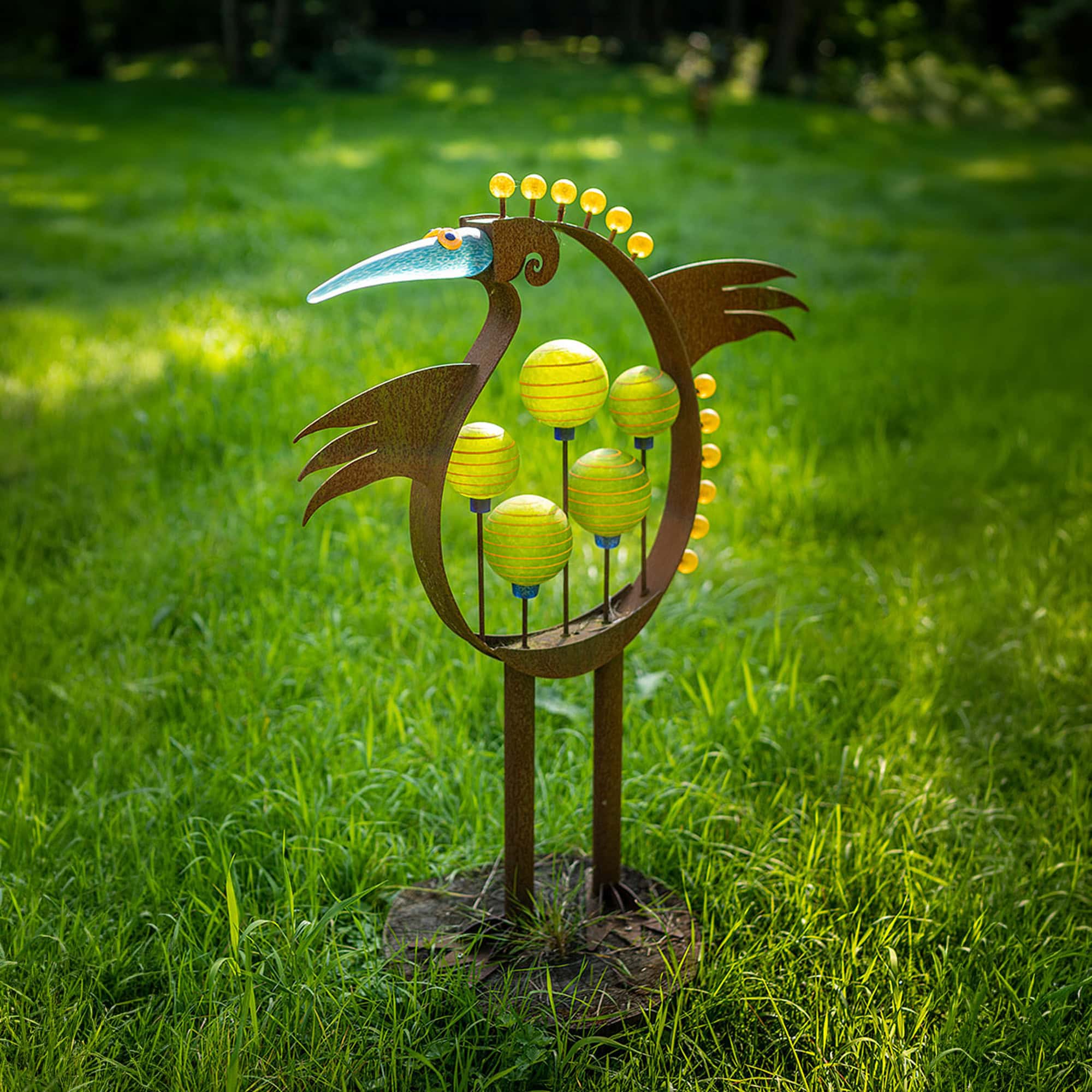 Artistic bird sculpture with colorful orbs, outdoor garden decor.