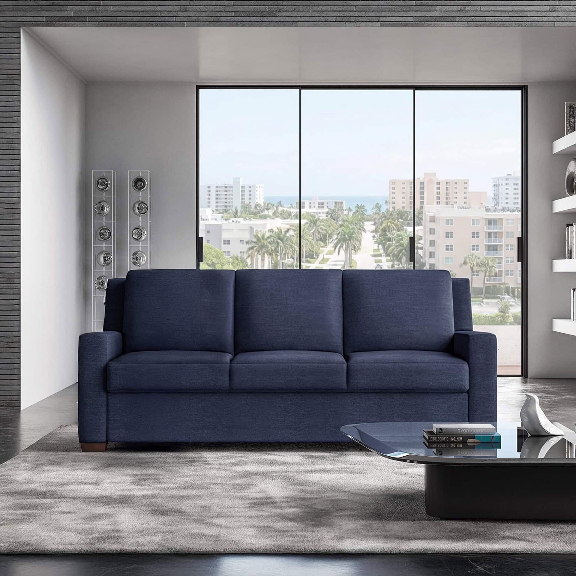 Luxury navy sofa in modern apartment with city skyline view.