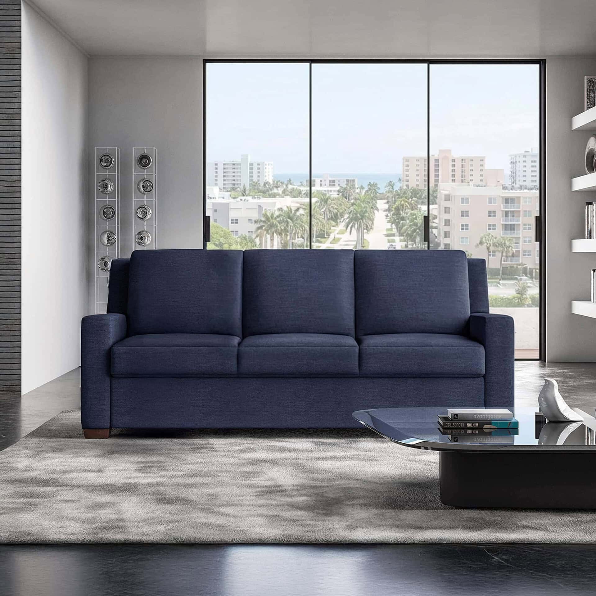 Luxury navy sofa in modern apartment with city skyline view.