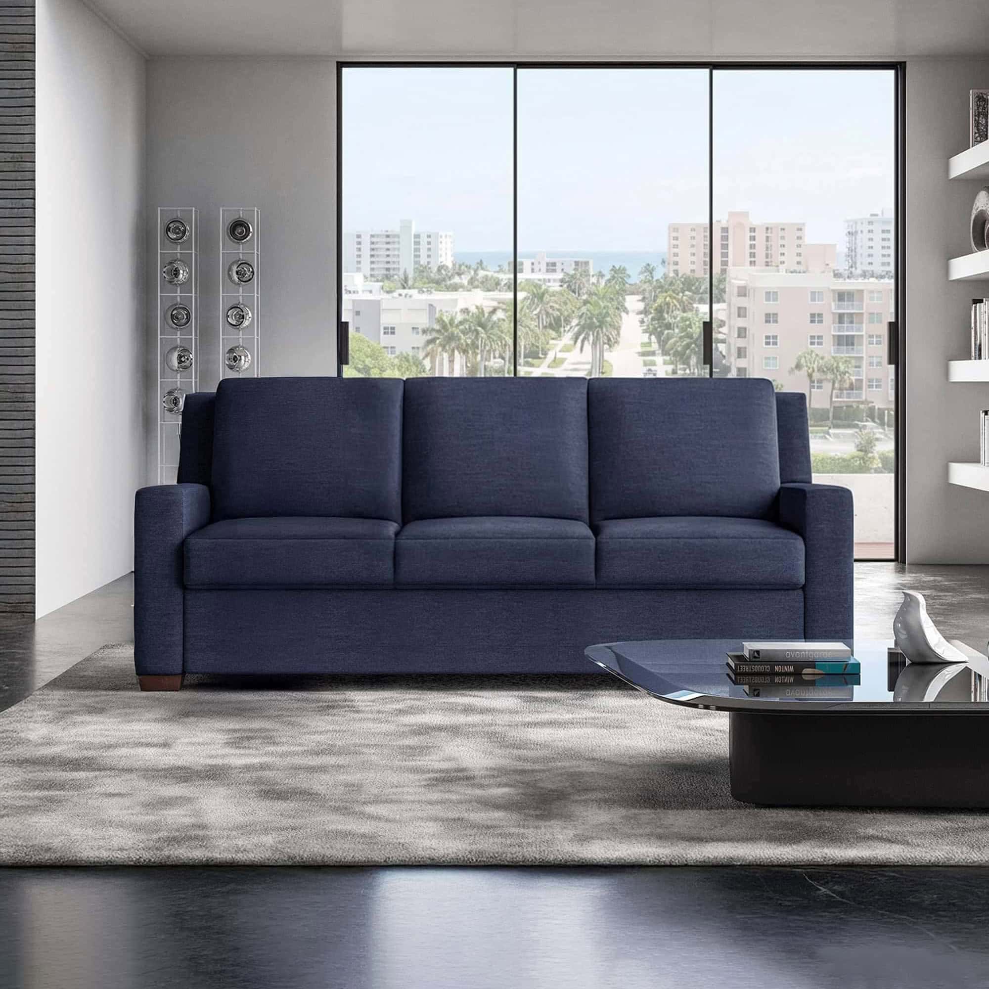 Luxury navy sofa in modern apartment with city skyline view.