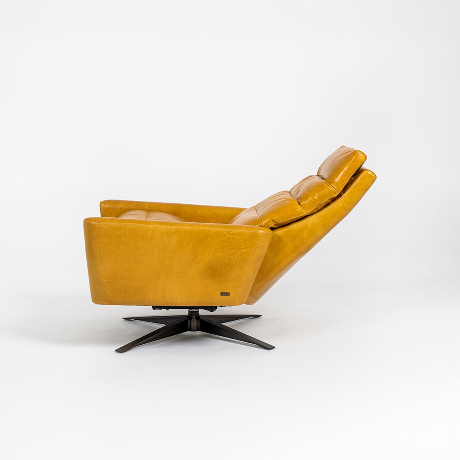 A mustard yellow leather armchair with a reclined backrest and a dark four-pronged swivel base, viewed from the side-rear on a white background.