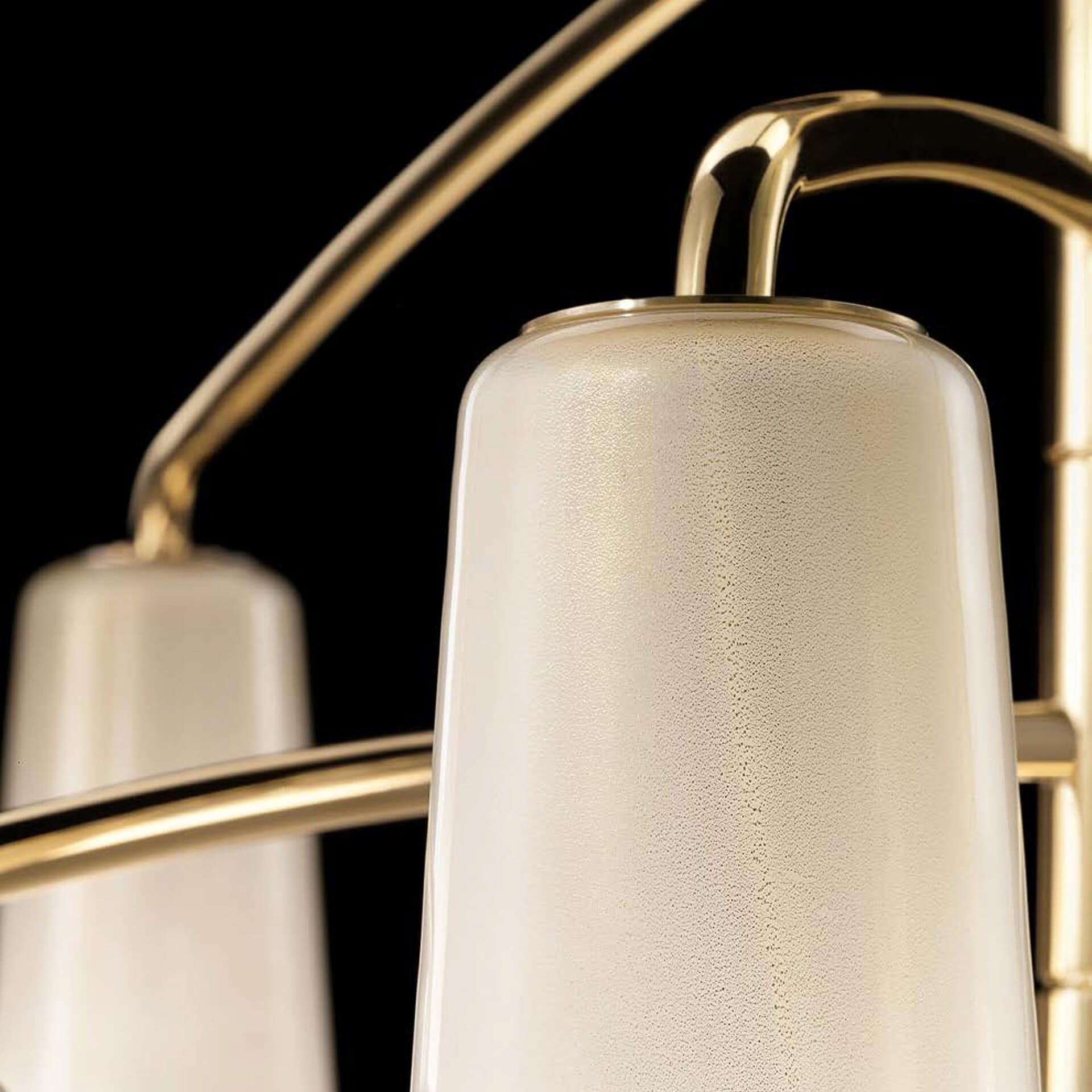Luxurious chandelier with frosted glass shades and gold finish, ideal for upscale interior lighting design.