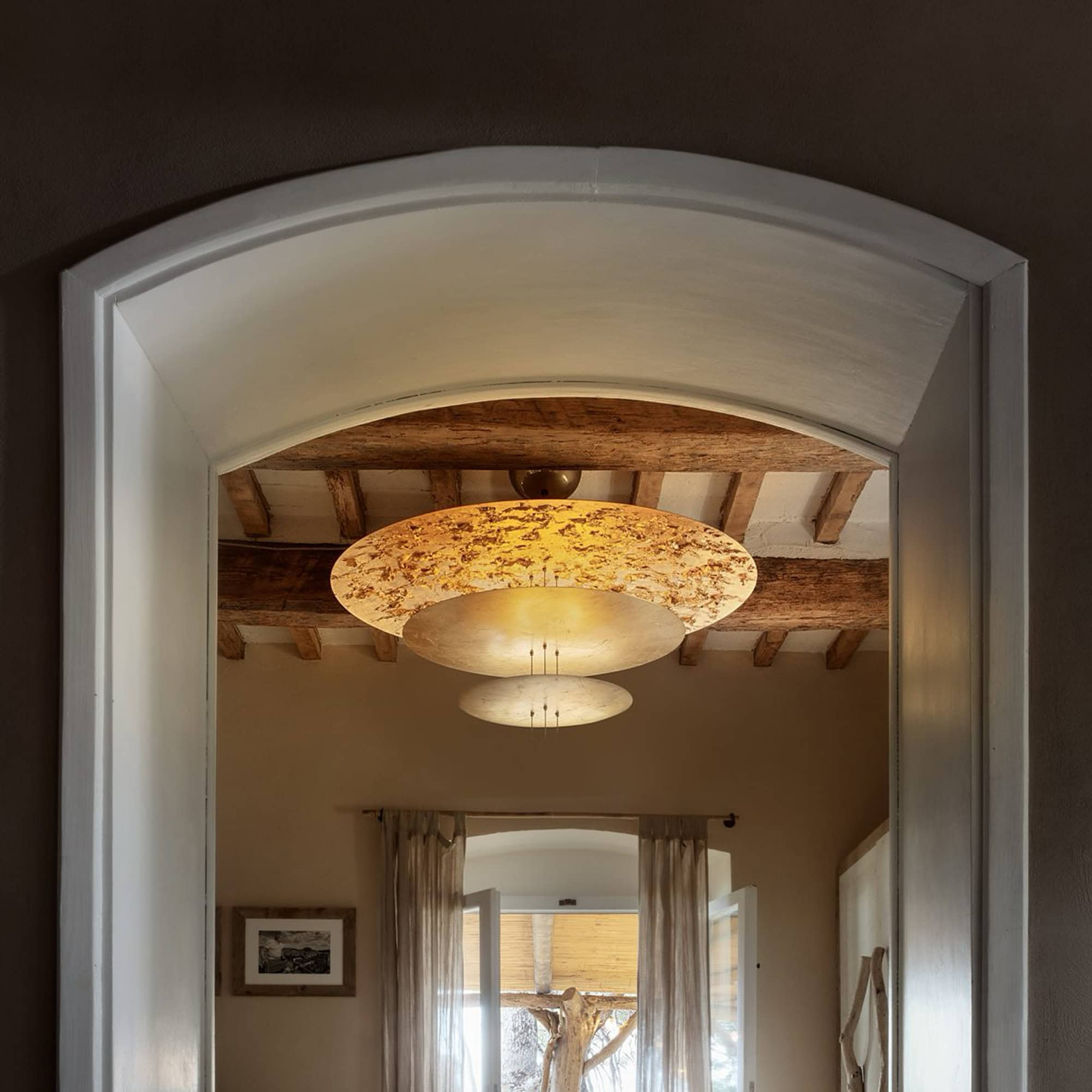 Macchina della Luce Pendant Light illuminating a hallway with arched entry.