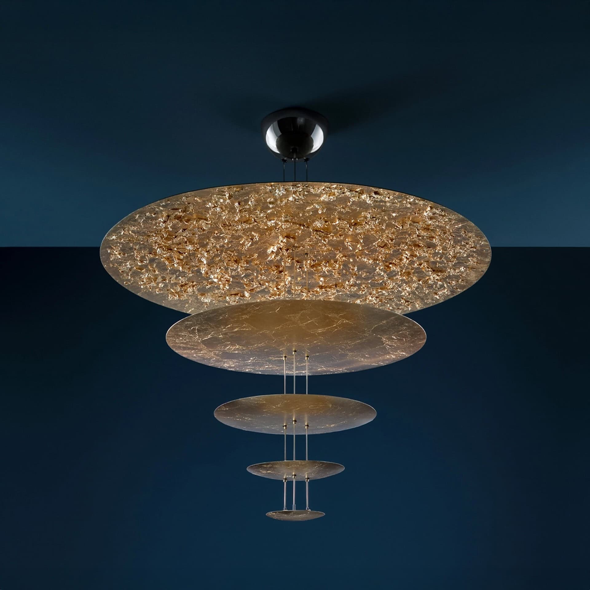 Macchina della Luce Pendant Light showcasing its glowing gold leaf discs.