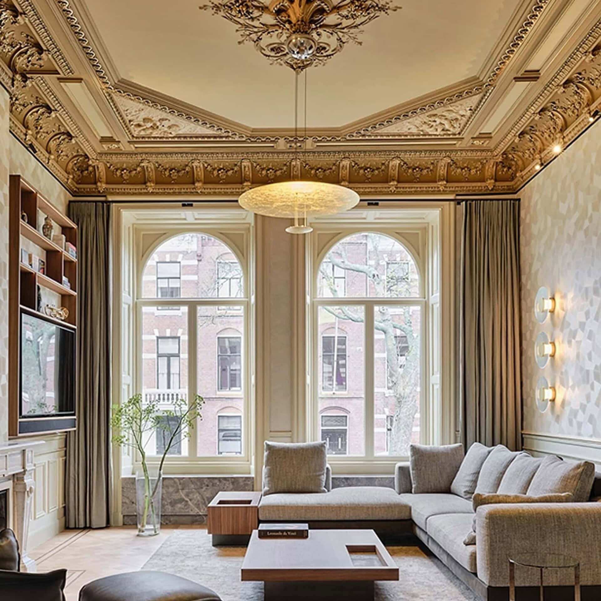 Macchina della Luce Pendant Light in a grand living room with ornate ceiling details.