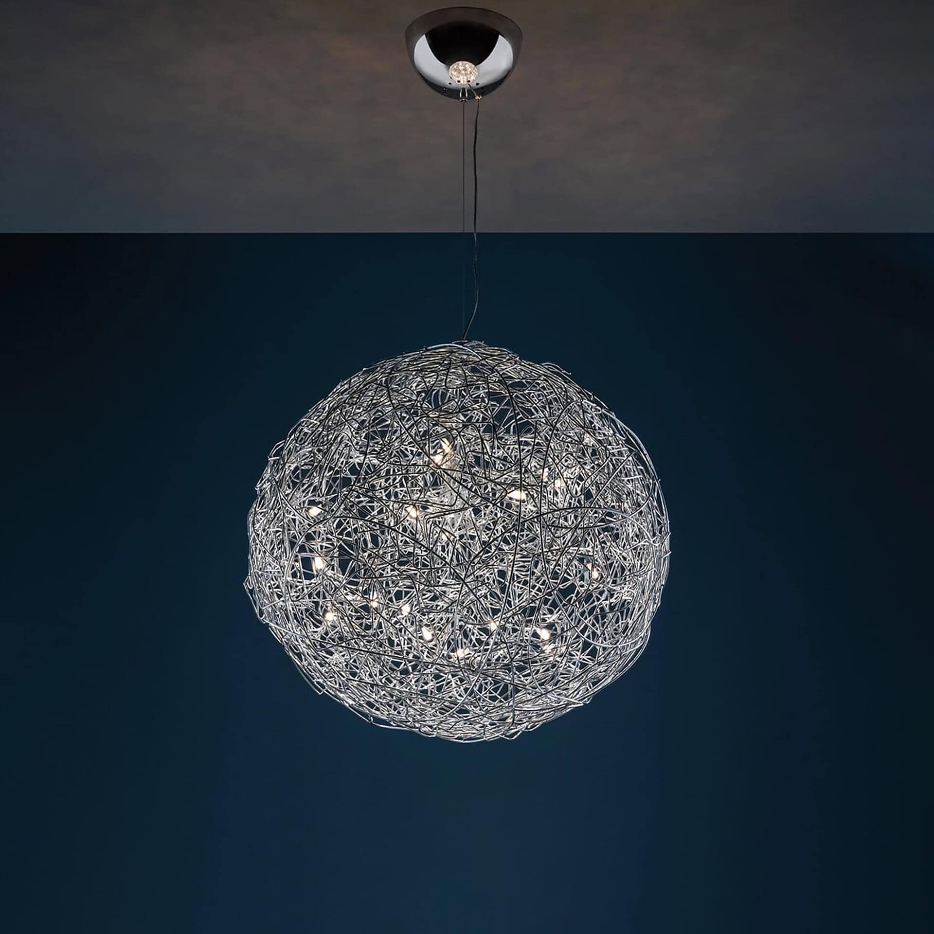 Pendant light with intricate wire sphere design, hanging from the ceiling.