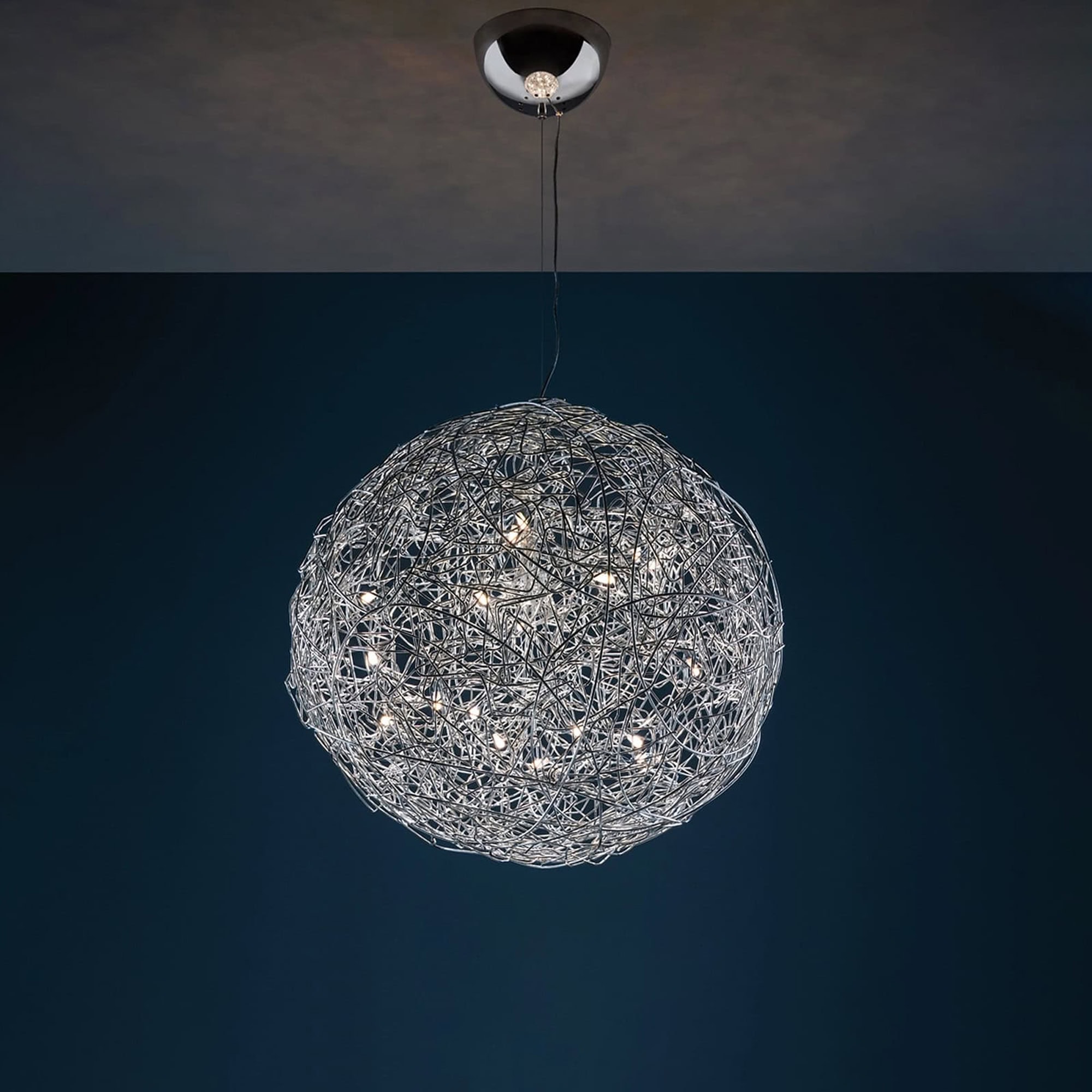 Pendant light with intricate wire sphere design, hanging from the ceiling.