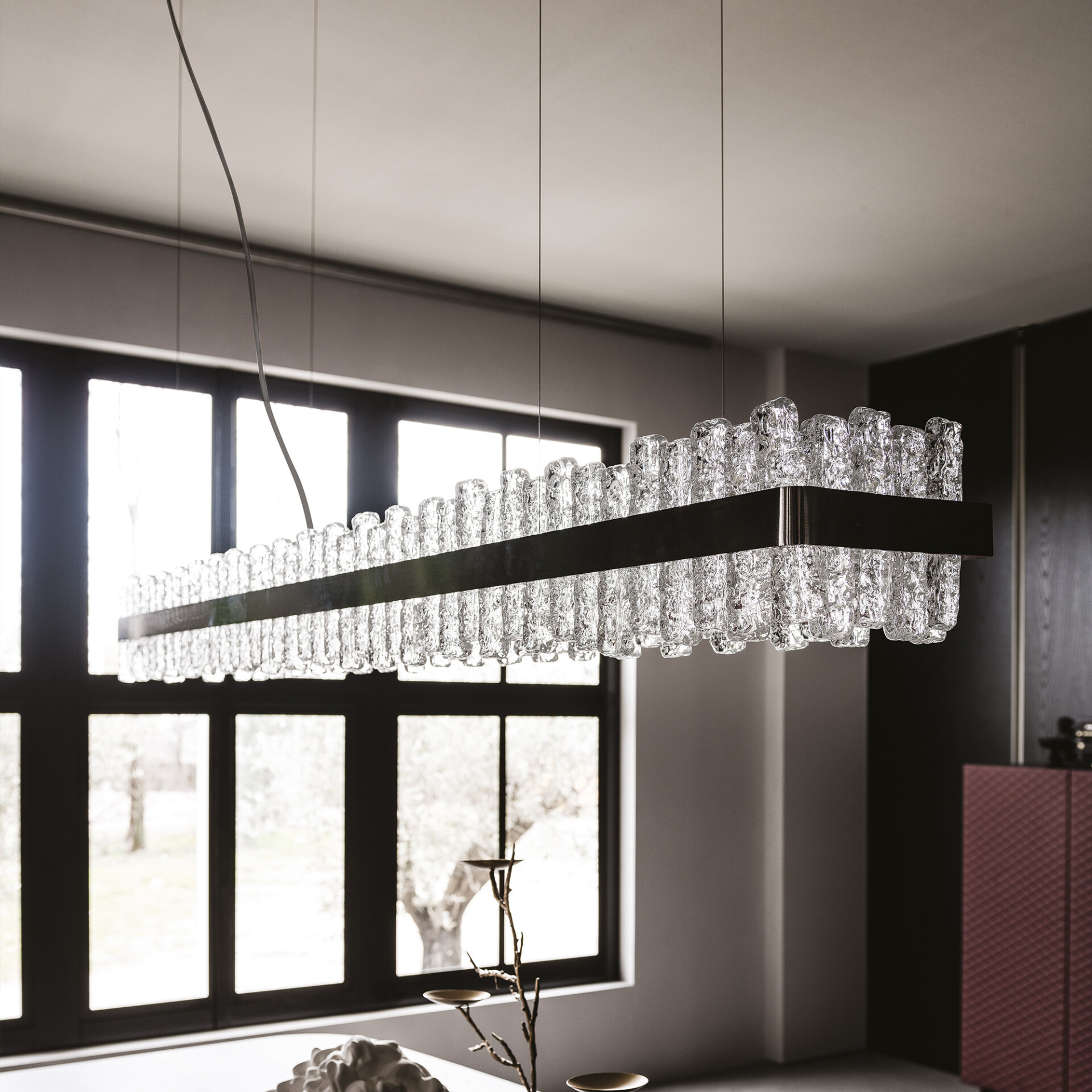 Modern dining room with rectangular Phoenix LED Handmade Glass Chandelier in satin nickel finish.