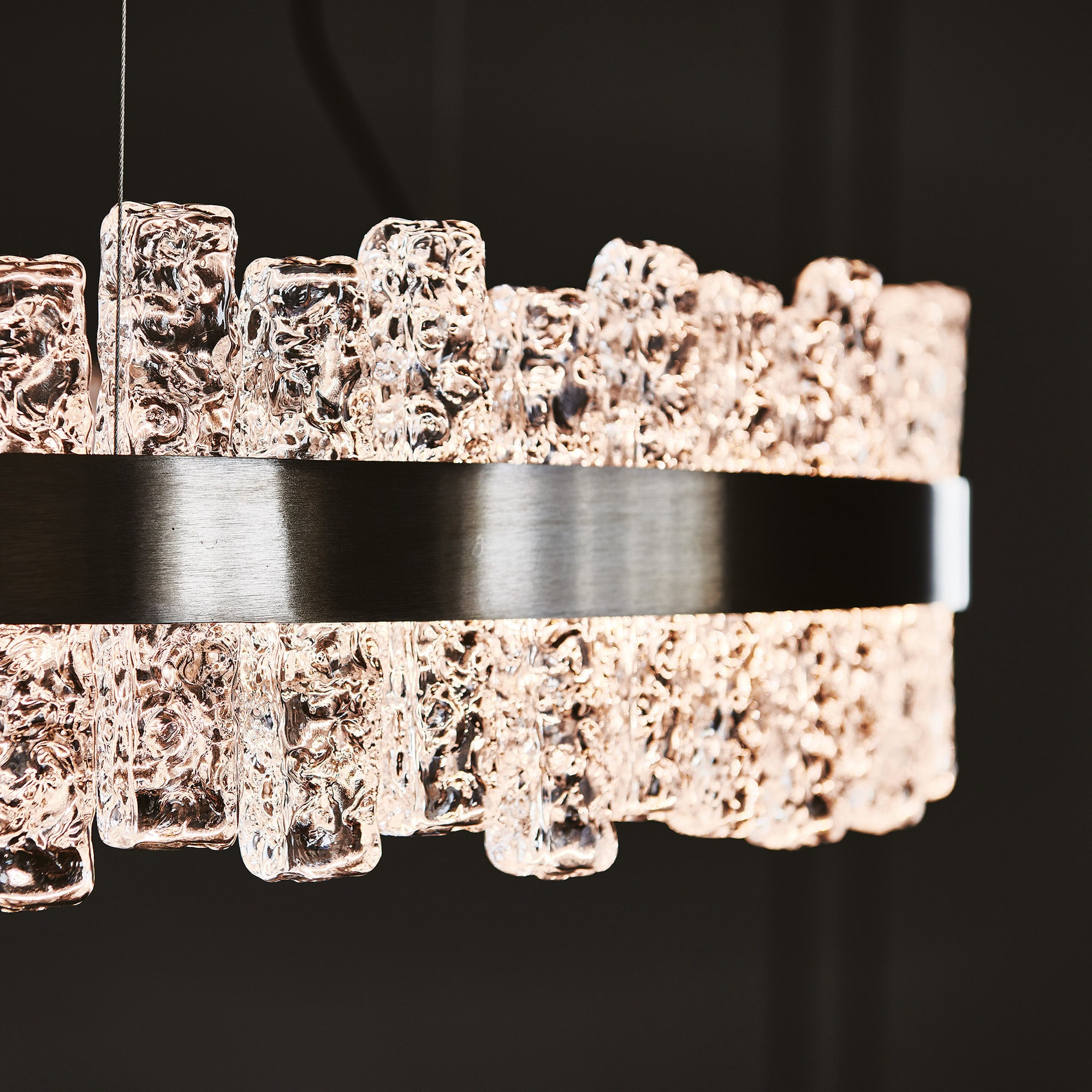 Detailed view of Phoenix LED Handmade Glass Chandelier’s handcrafted glass elements illuminated.