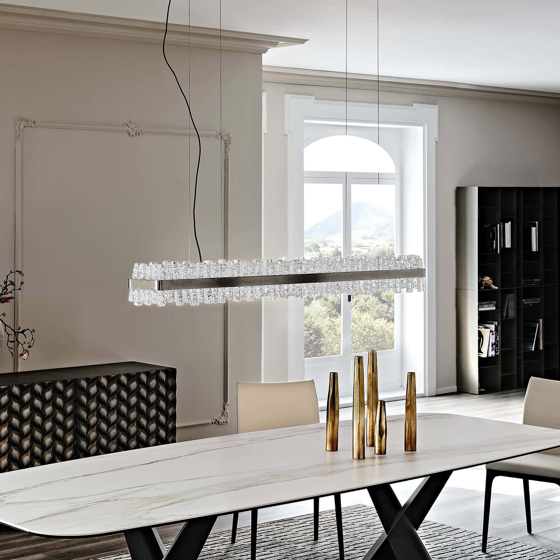 Rectangular Phoenix LED Handmade Glass Chandelier installed in bright dining space with white walls.