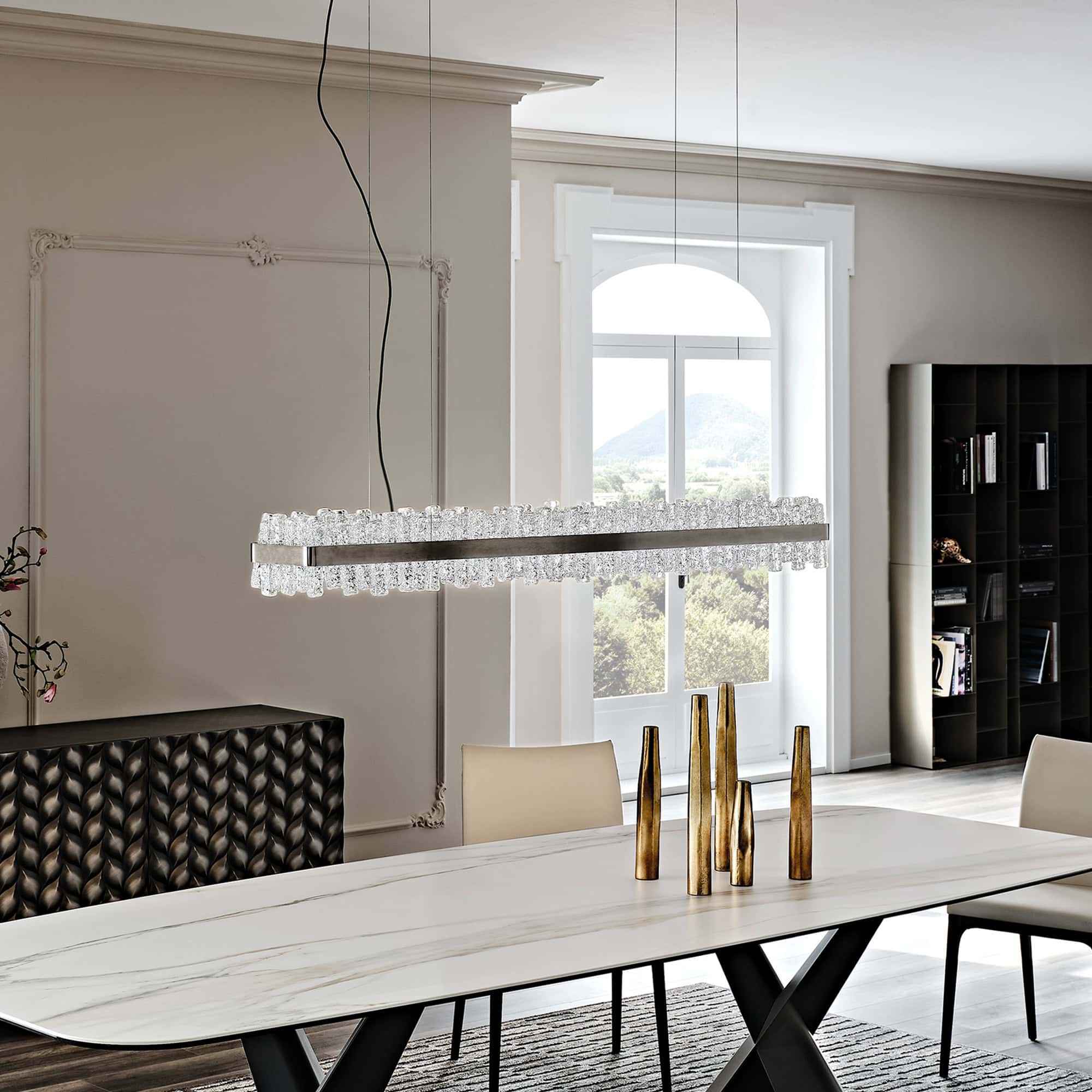 Rectangular Phoenix LED Handmade Glass Chandelier installed in bright dining space with white walls.