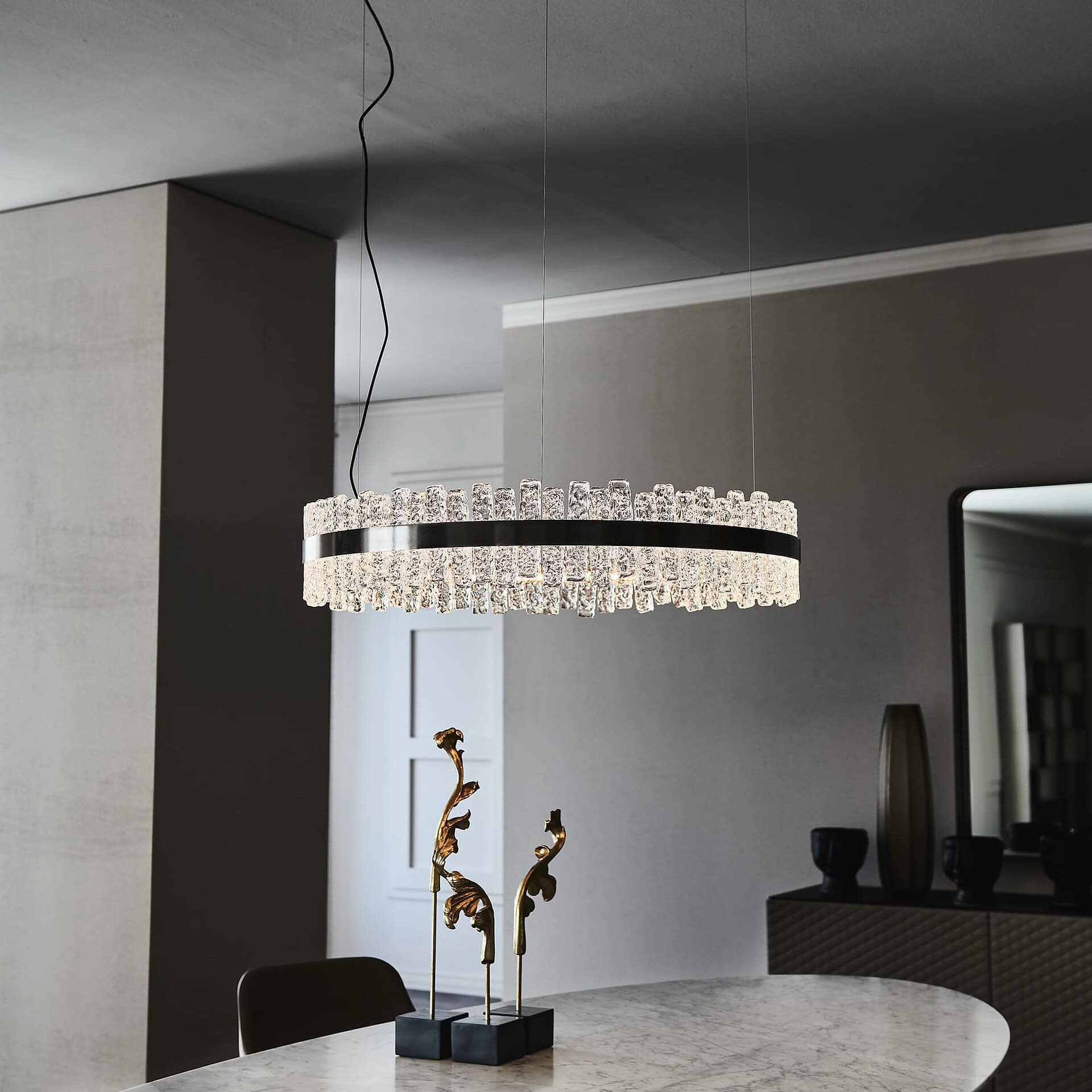 Circular Phoenix LED Handmade Glass Chandelier glowing in a contemporary dining room.