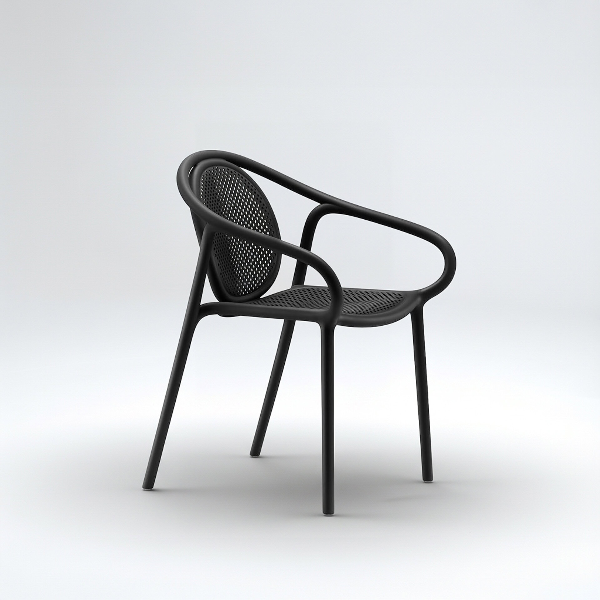 Pedrali Remind 3735 Armchair in black polypropylene, angled side view highlighting curved silhouette