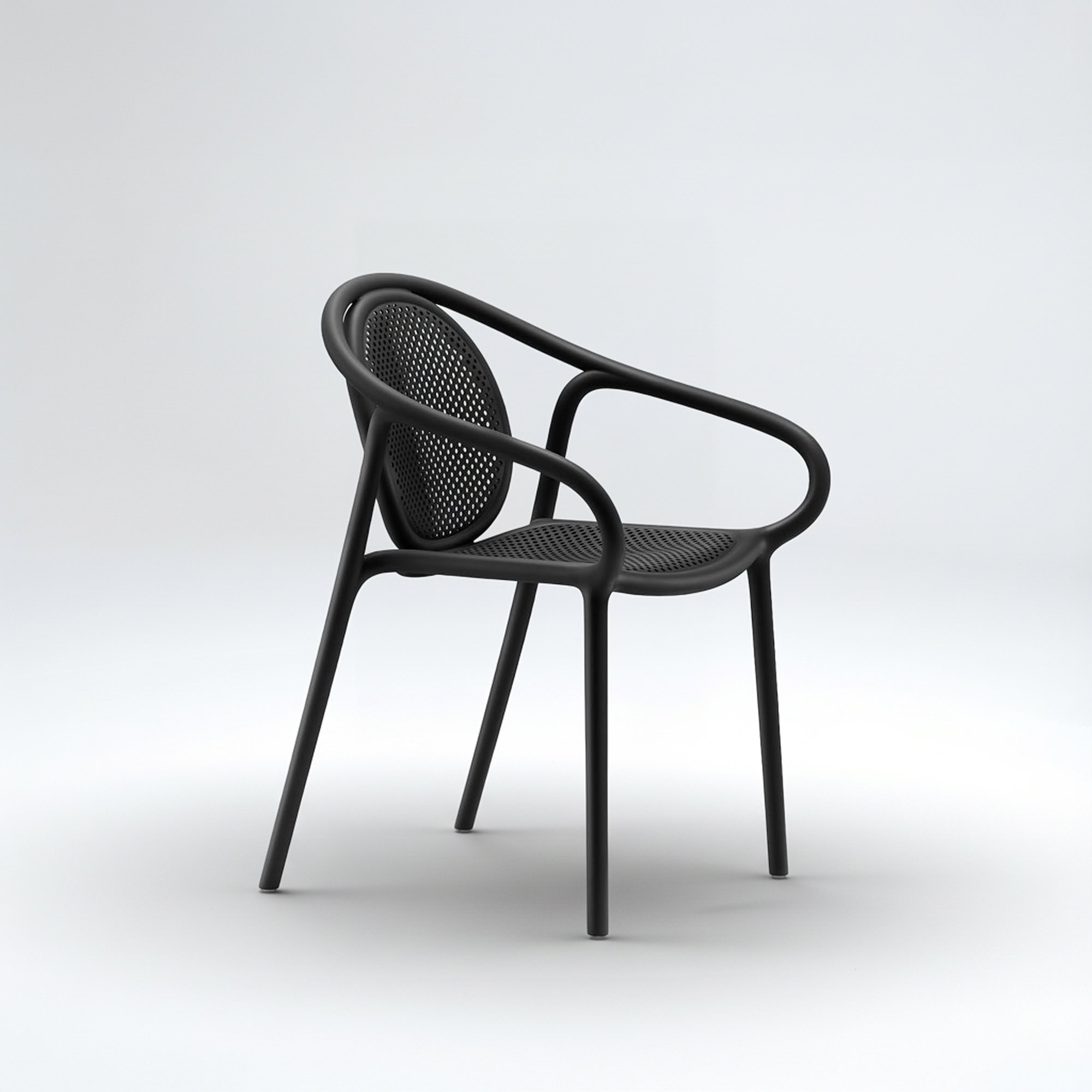 Pedrali Remind 3735 Armchair in black polypropylene, angled side view highlighting curved silhouette