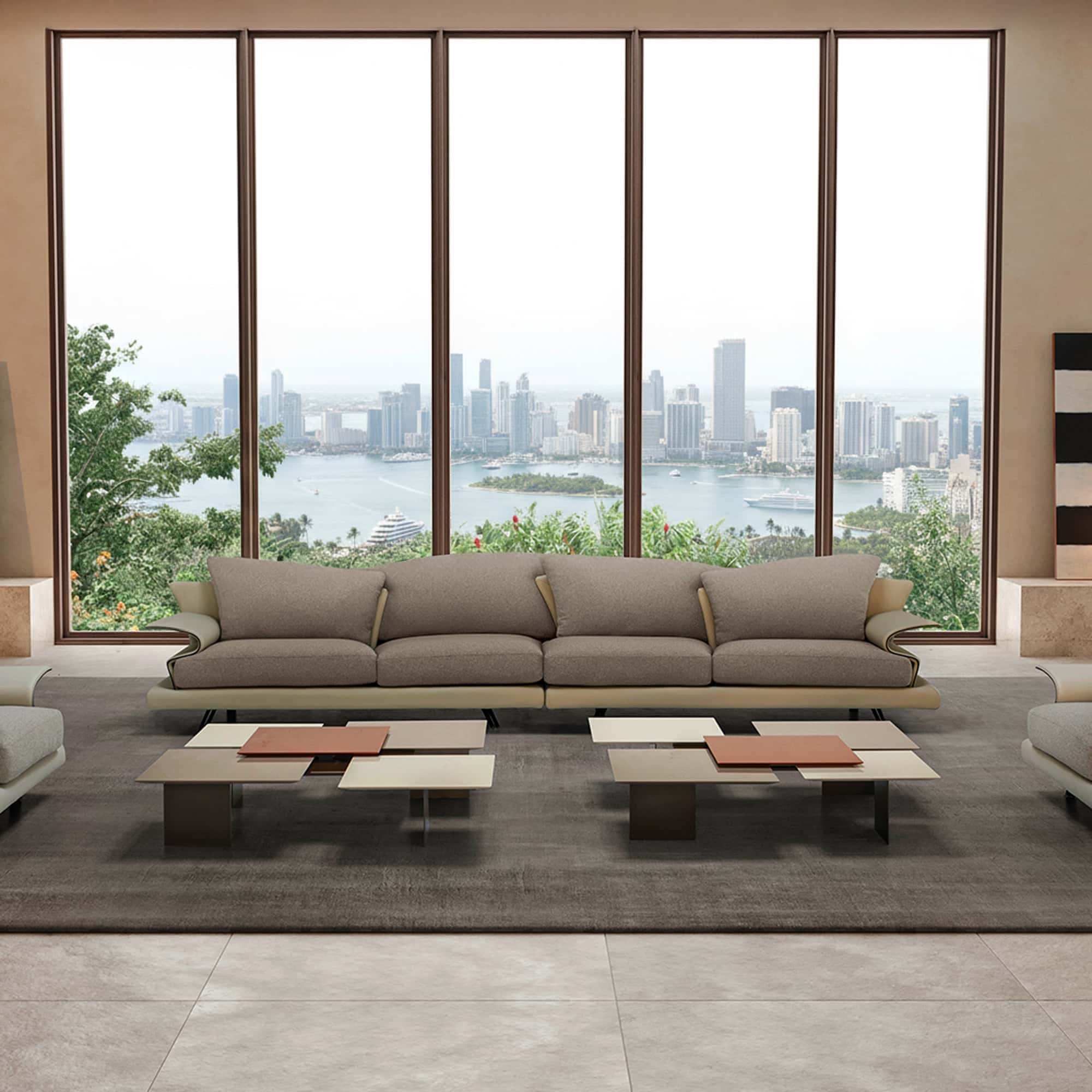 Elegant modern living room with expansive city skyline view, featuring Sklar Furnishings sofa and stylish coffee tables.