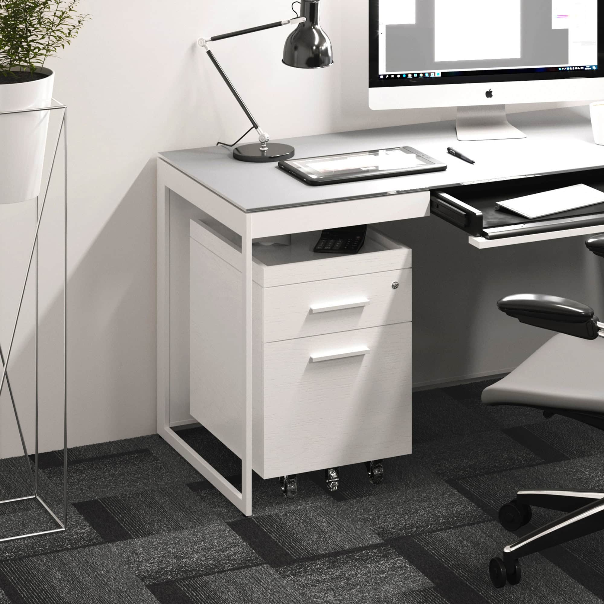 Clean white office desk with drawers and a computer setup, showcasing modern furniture from Sklar Furnishings.