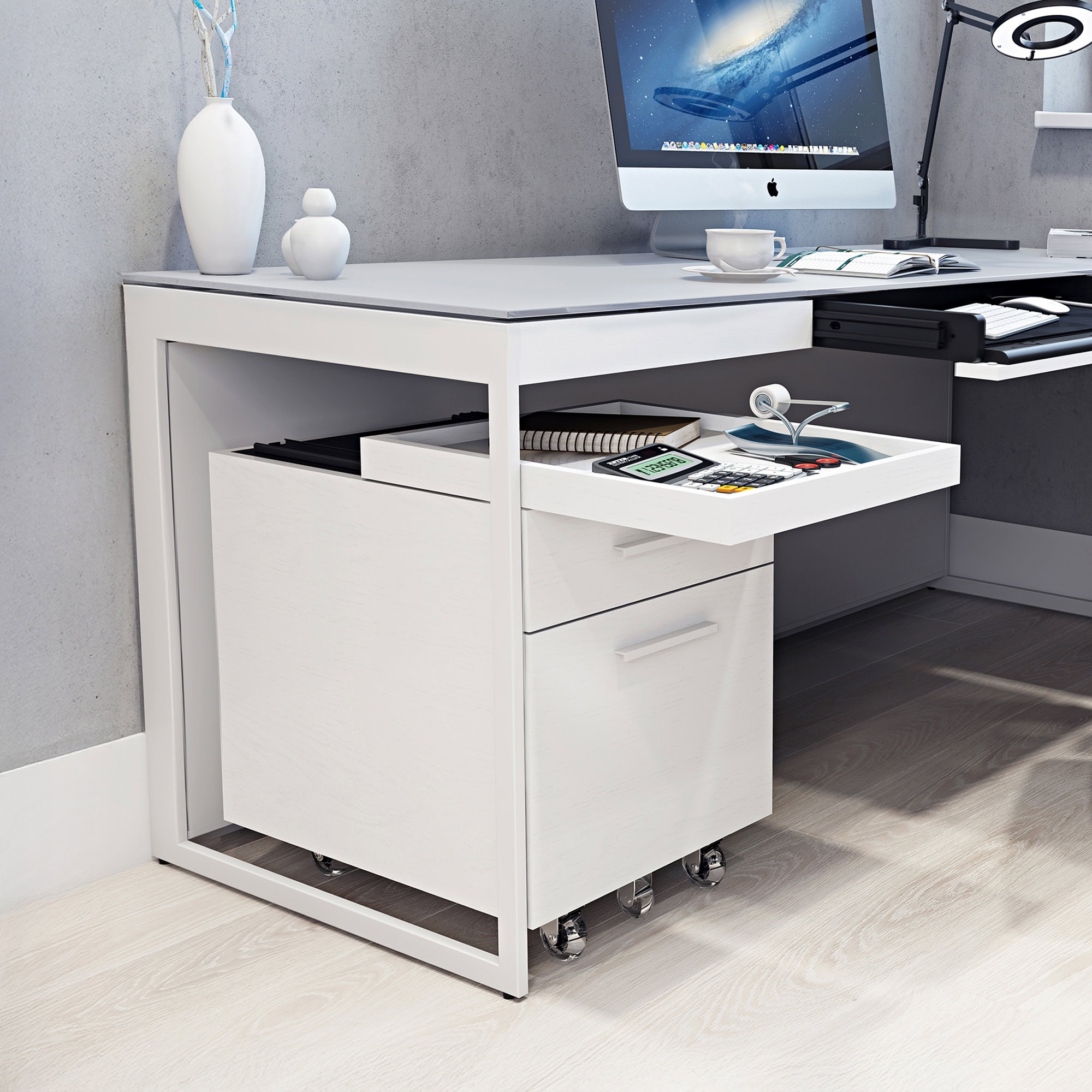 Modern white office desk with mobile storage and ergonomic workspace setup.