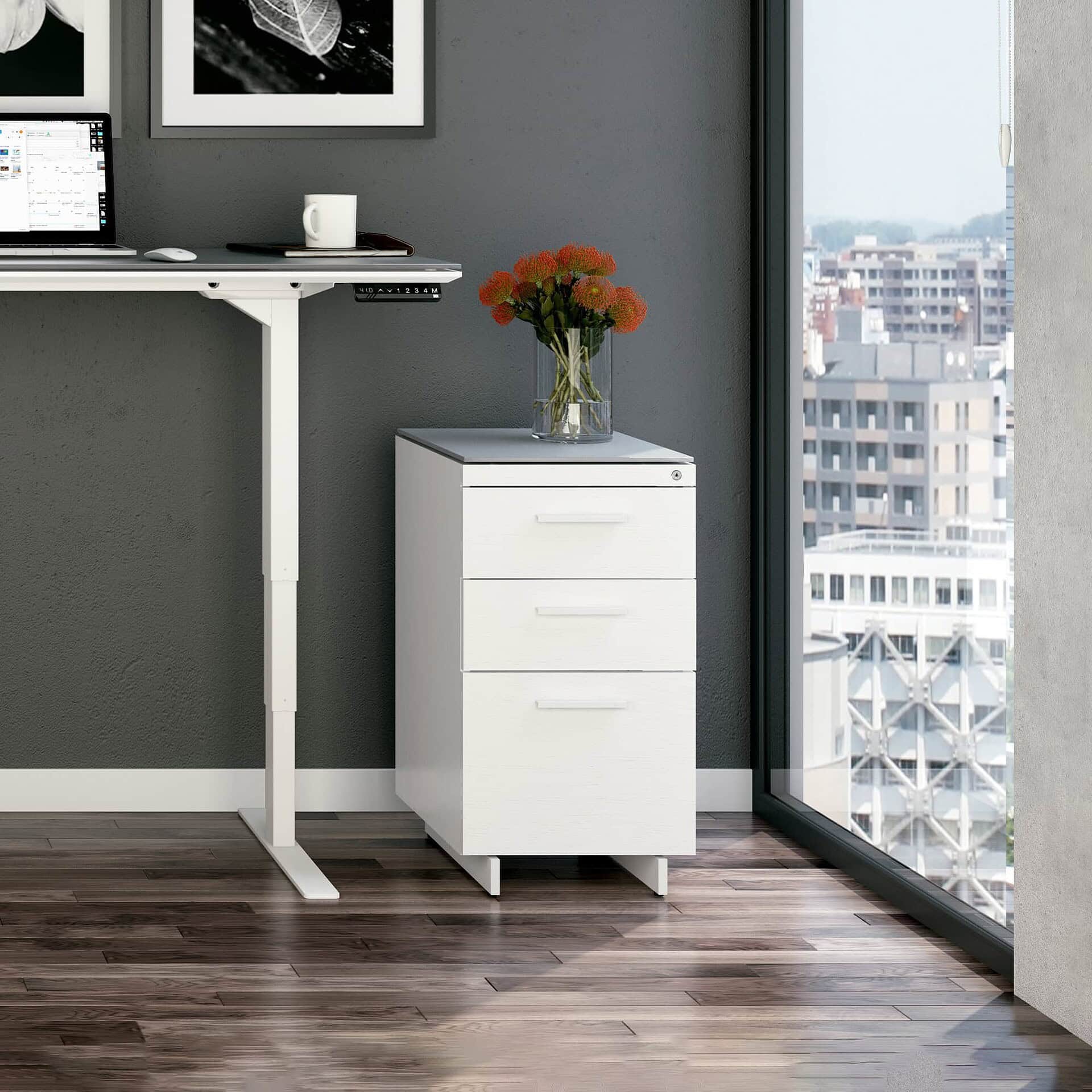 Modern white office filing cabinet with drawers, stylish decor, and city view.